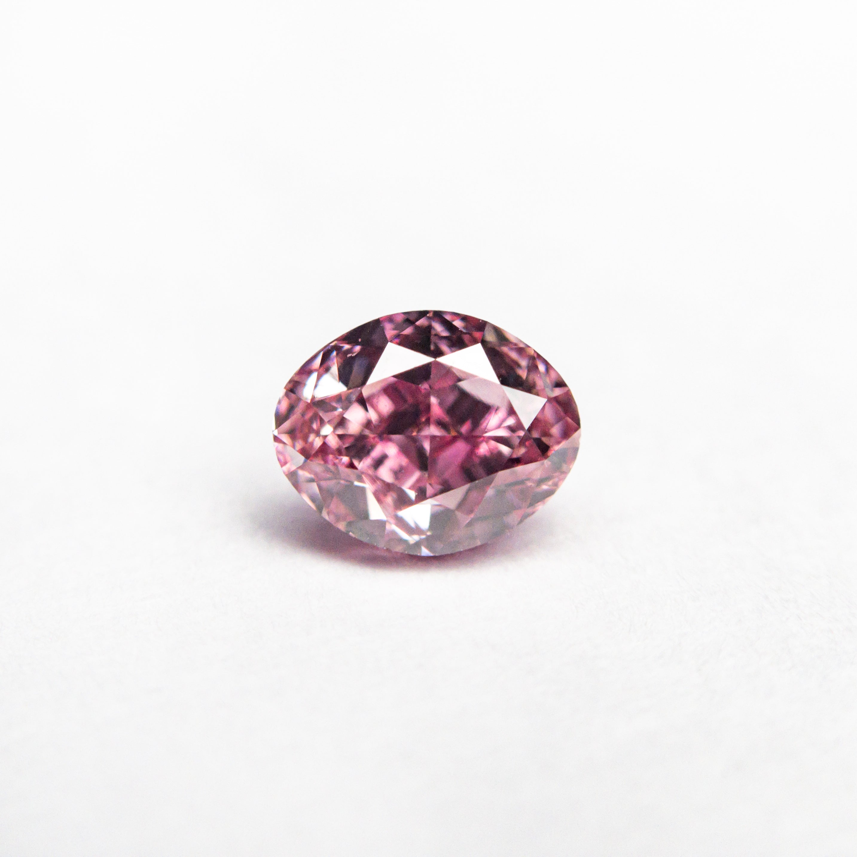 The 0.61ct 5.57x4.44x3.13mm GIA VS2 Fancy Vivid Purplish Pink Oval Brilliant 🇦🇺 24137-01 by East London jeweller Rachel Boston | Discover our collections of unique and timeless engagement rings, wedding rings, and modern fine jewellery.