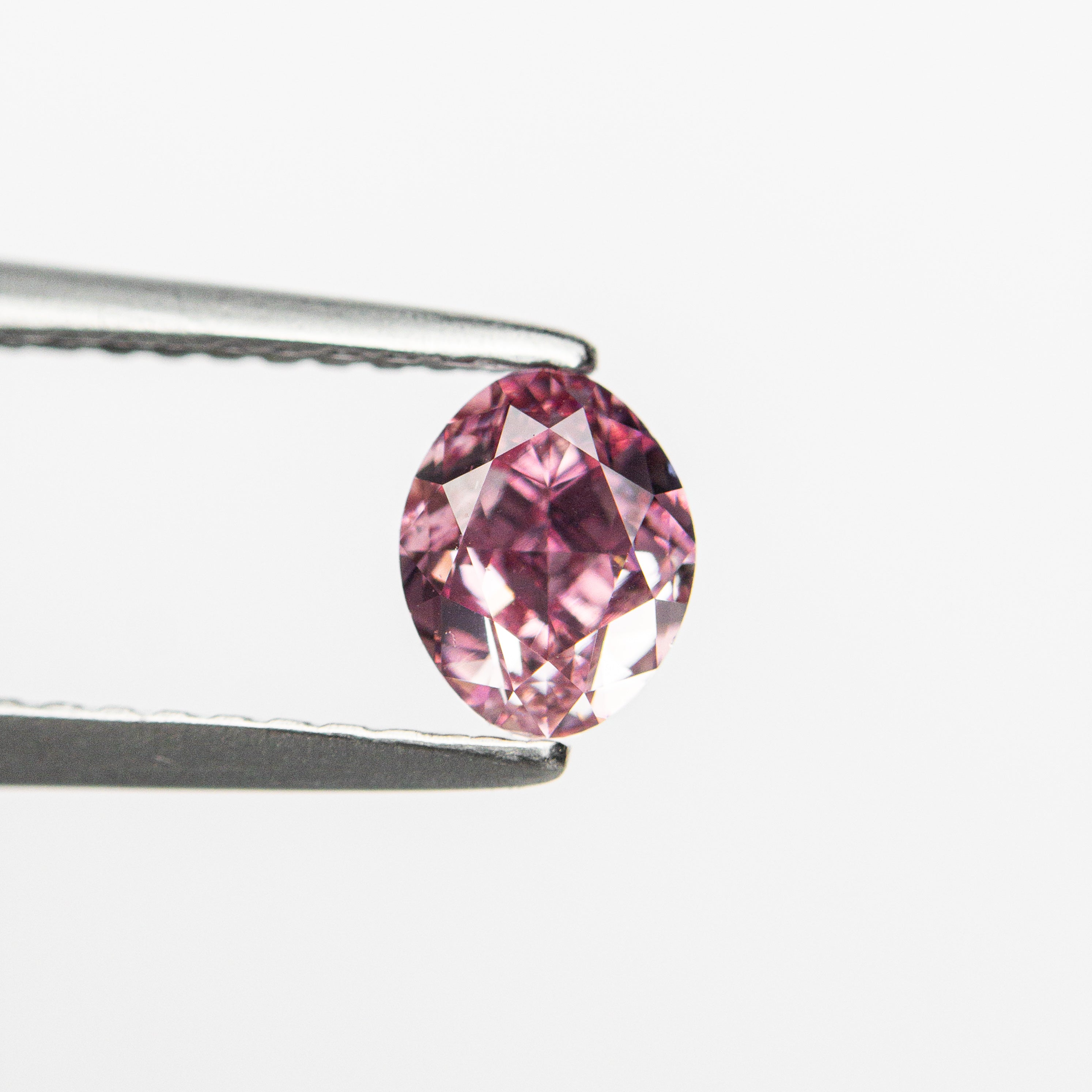 The 0.61ct 5.57x4.44x3.13mm GIA VS2 Fancy Vivid Purplish Pink Oval Brilliant 🇦🇺 24137-01 by East London jeweller Rachel Boston | Discover our collections of unique and timeless engagement rings, wedding rings, and modern fine jewellery.