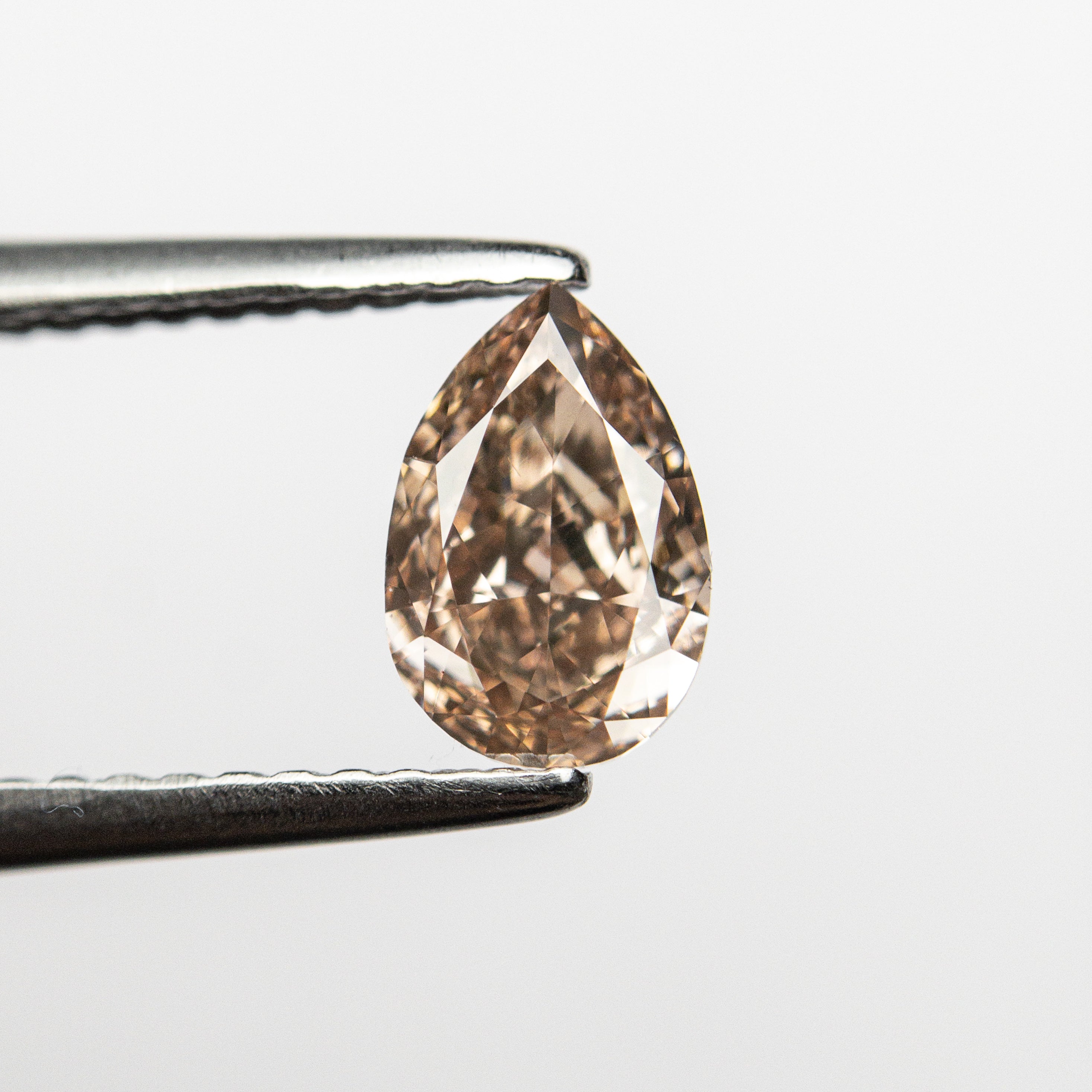 The 0.68ct 7.06x4.68x2.76mm VS2 Fancy Brownish Pink Pear Brilliant 🇦🇺 24112-01 by East London jeweller Rachel Boston | Discover our collections of unique and timeless engagement rings, wedding rings, and modern fine jewellery.