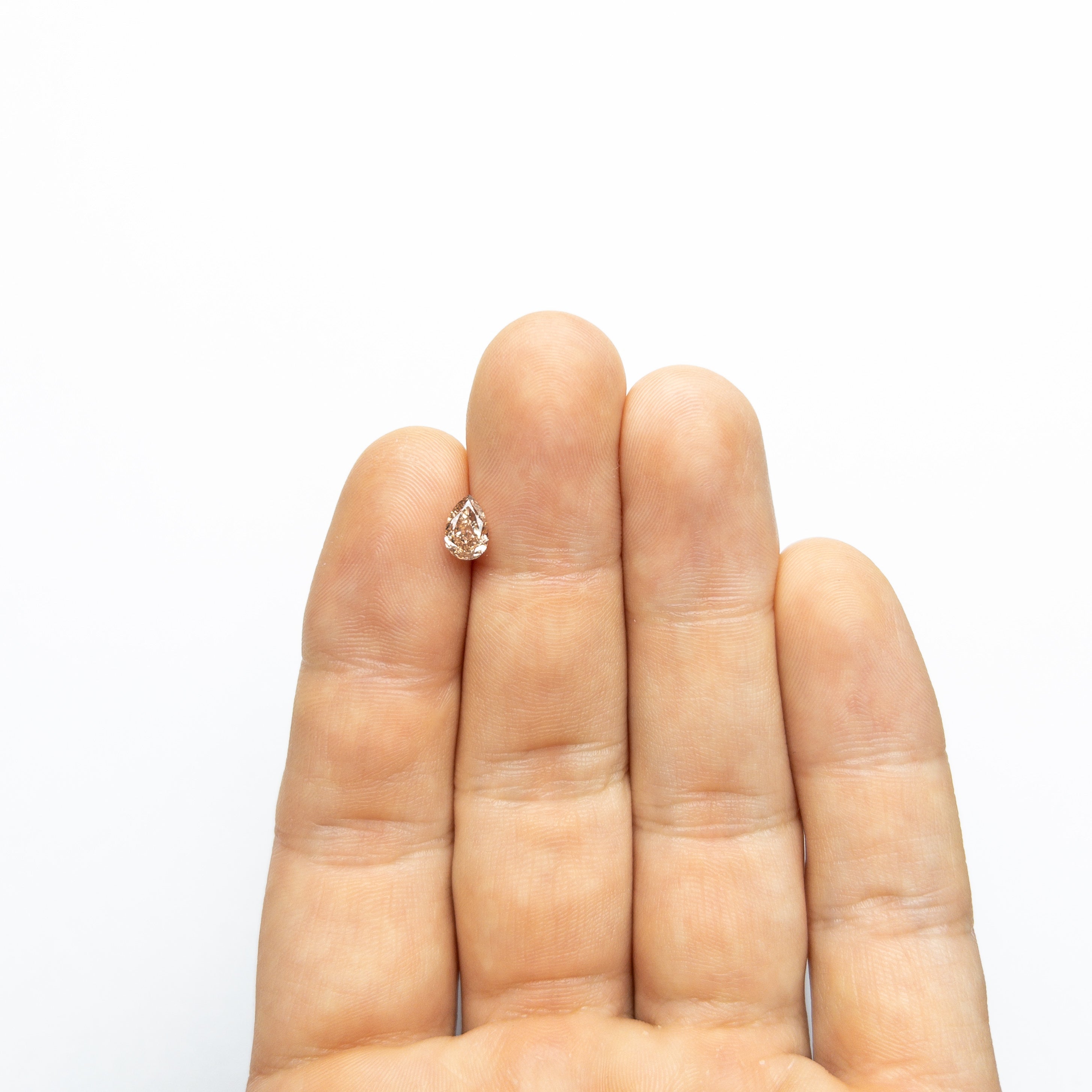 The 0.68ct 7.06x4.68x2.76mm VS2 Fancy Brownish Pink Pear Brilliant 🇦🇺 24112-01 by East London jeweller Rachel Boston | Discover our collections of unique and timeless engagement rings, wedding rings, and modern fine jewellery.