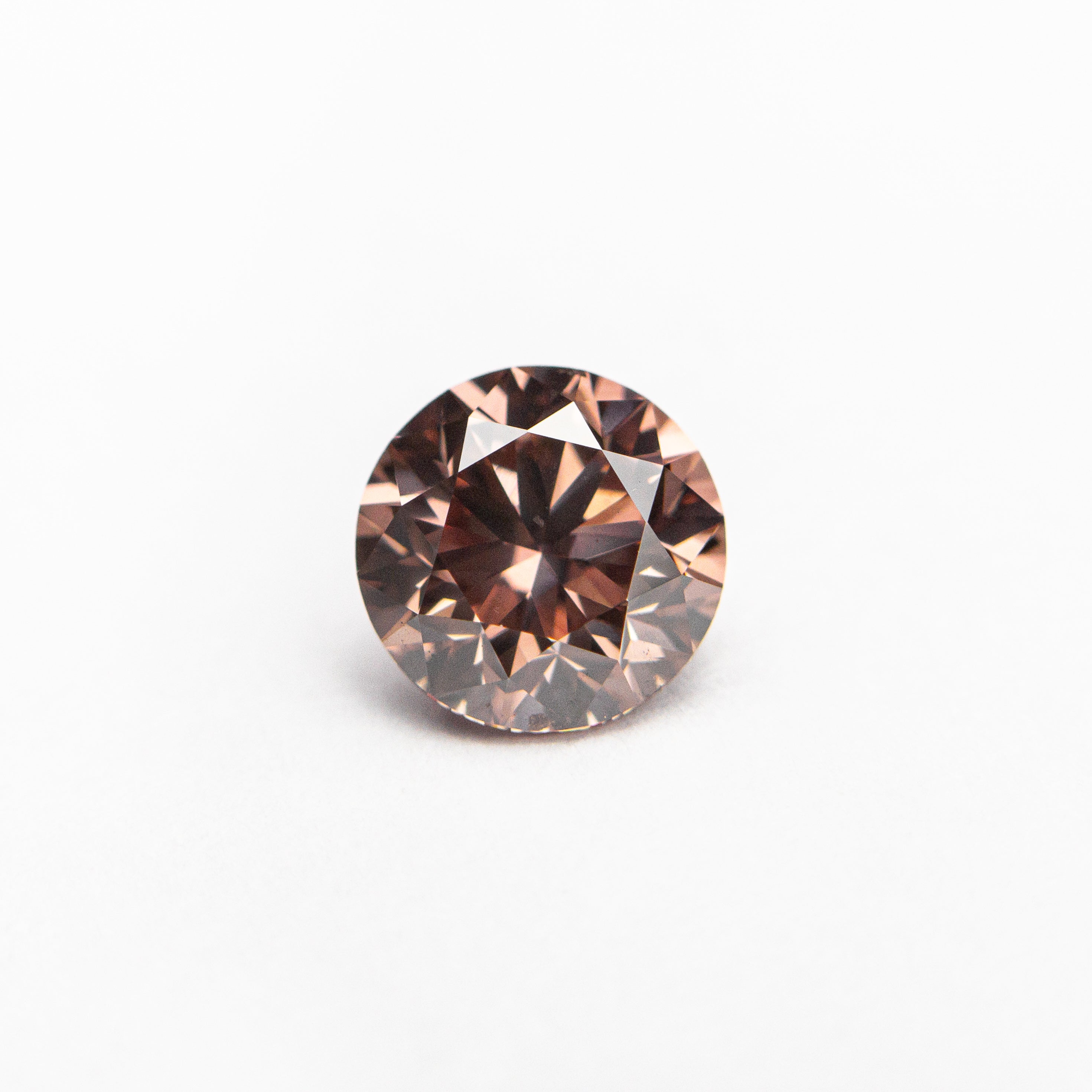 The 0.70ct 5.51x5.48x3.62 GIA SI1 Fancy Deep Orangy Pink Round Brilliant 🇦🇺 24147-01 by East London jeweller Rachel Boston | Discover our collections of unique and timeless engagement rings, wedding rings, and modern fine jewellery.