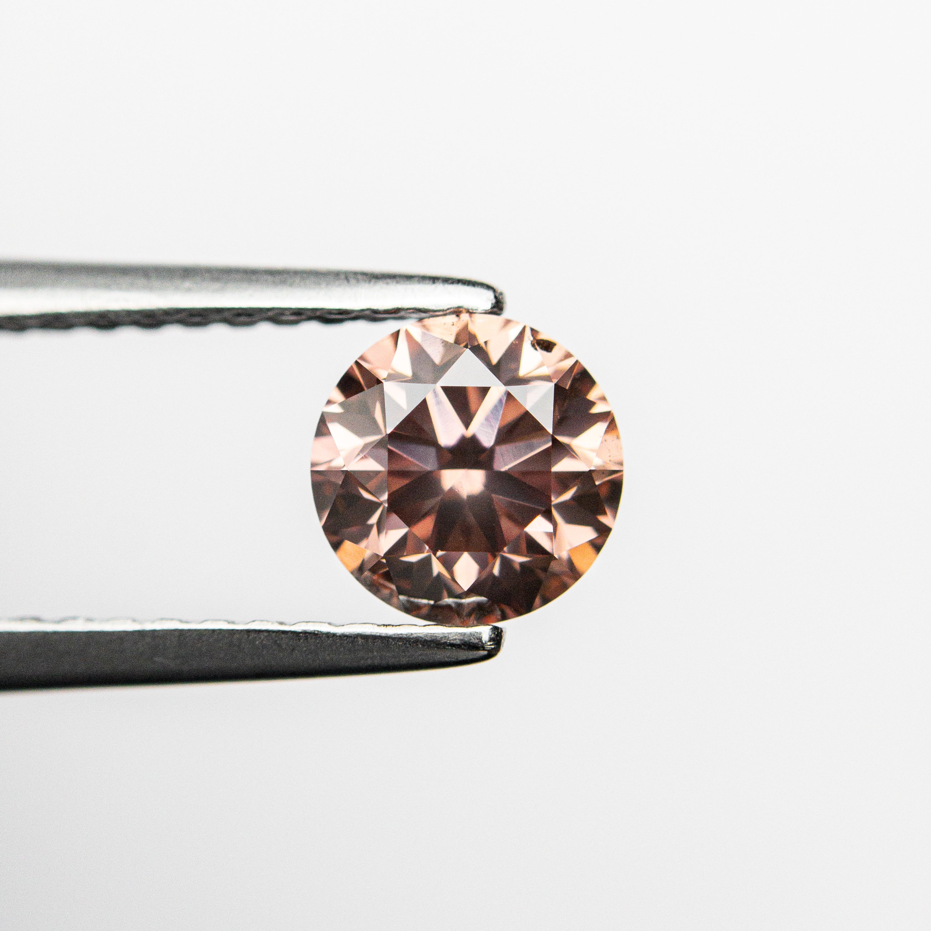 The 0.70ct 5.51x5.48x3.62 GIA SI1 Fancy Deep Orangy Pink Round Brilliant 🇦🇺 24147-01 by East London jeweller Rachel Boston | Discover our collections of unique and timeless engagement rings, wedding rings, and modern fine jewellery.