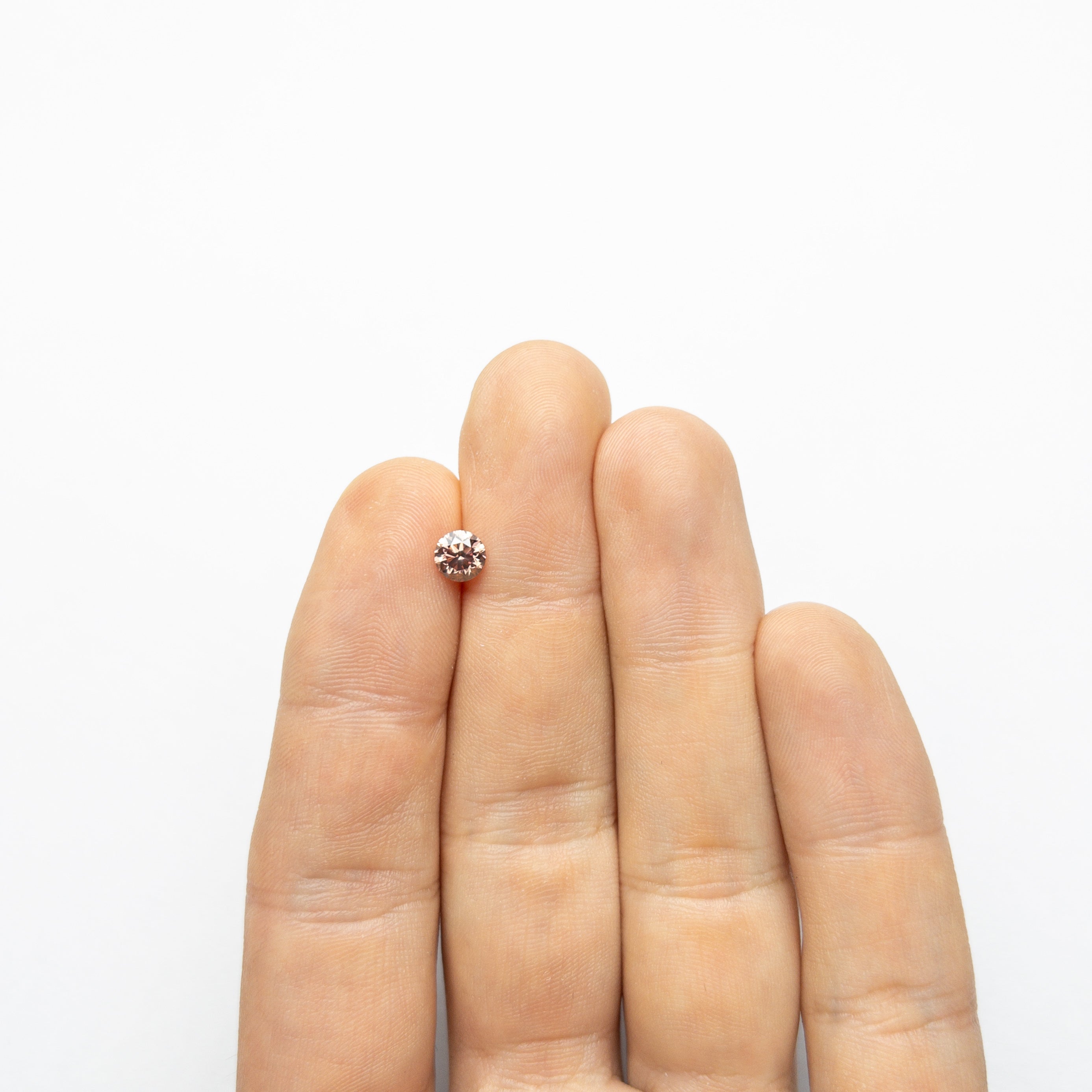 The 0.70ct 5.51x5.48x3.62 GIA SI1 Fancy Deep Orangy Pink Round Brilliant 🇦🇺 24147-01 by East London jeweller Rachel Boston | Discover our collections of unique and timeless engagement rings, wedding rings, and modern fine jewellery.