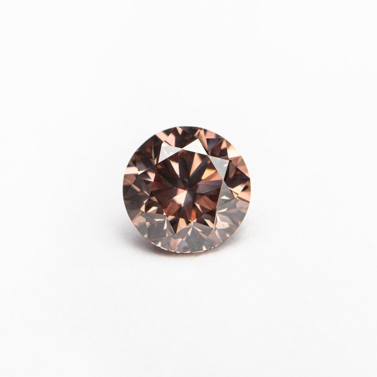 The 0.70ct 5.51x5.48x3.62mm GIA SI1 Fancy Deep Orangy Pink Round Brilliant 🇦🇺 24147-01 by East London jeweller Rachel Boston | Discover our collections of unique and timeless engagement rings, wedding rings, and modern fine jewellery.