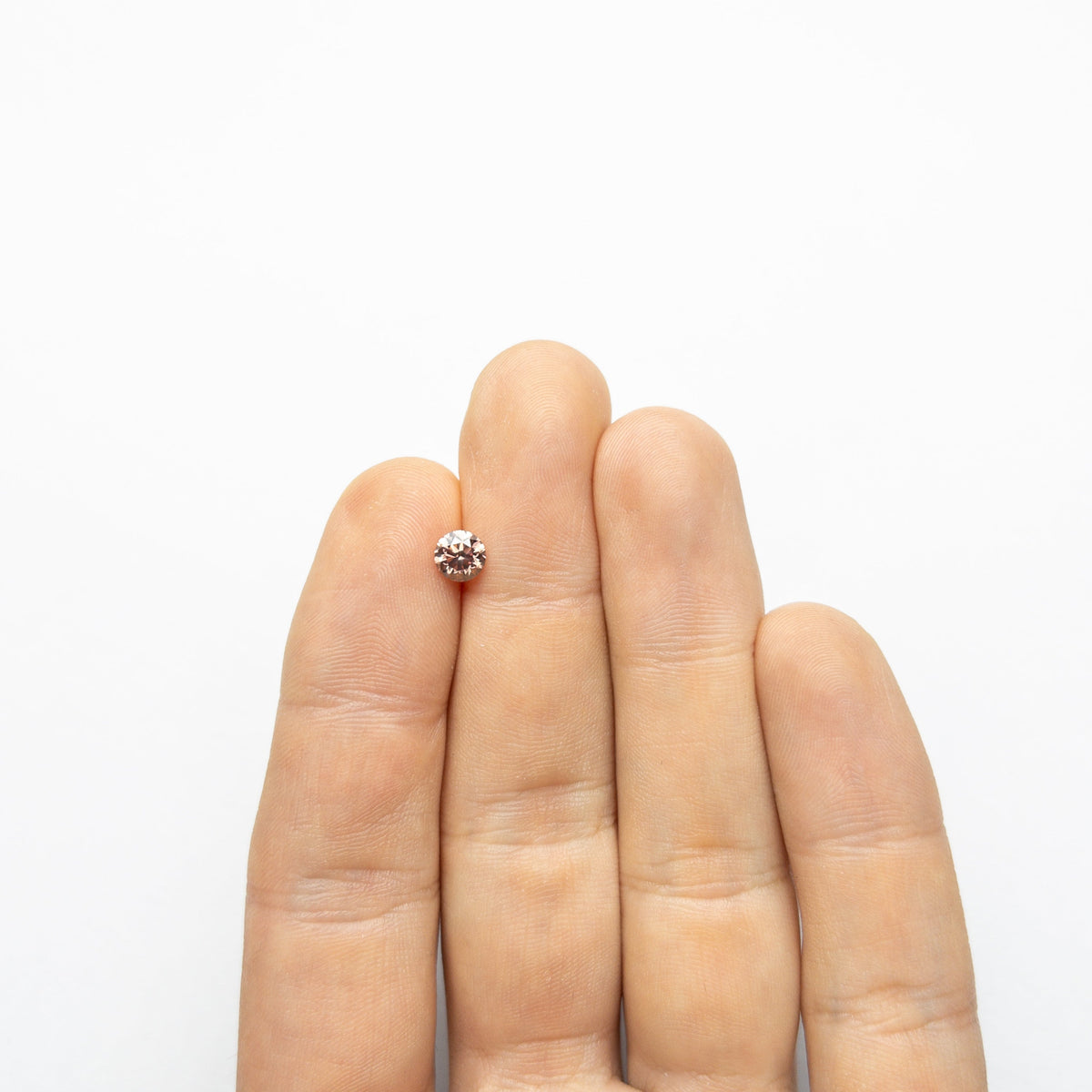 The 0.70ct 5.51x5.48x3.62mm GIA SI1 Fancy Deep Orangy Pink Round Brilliant 🇦🇺 24147-01 by East London jeweller Rachel Boston | Discover our collections of unique and timeless engagement rings, wedding rings, and modern fine jewellery.