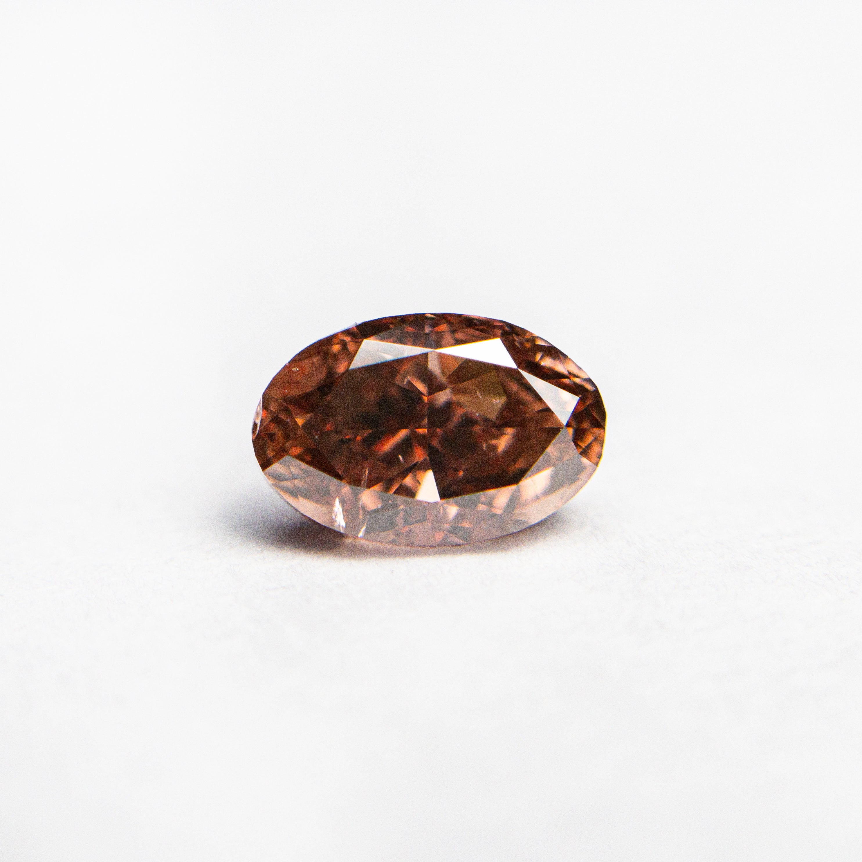 The 0.80ct 6.64x4.33x3.25mm GIA SI2 Fancy Deep Brownish Orangy Pink Oval Brilliant 🇦🇺 24162-01 by East London jeweller Rachel Boston | Discover our collections of unique and timeless engagement rings, wedding rings, and modern fine jewellery.