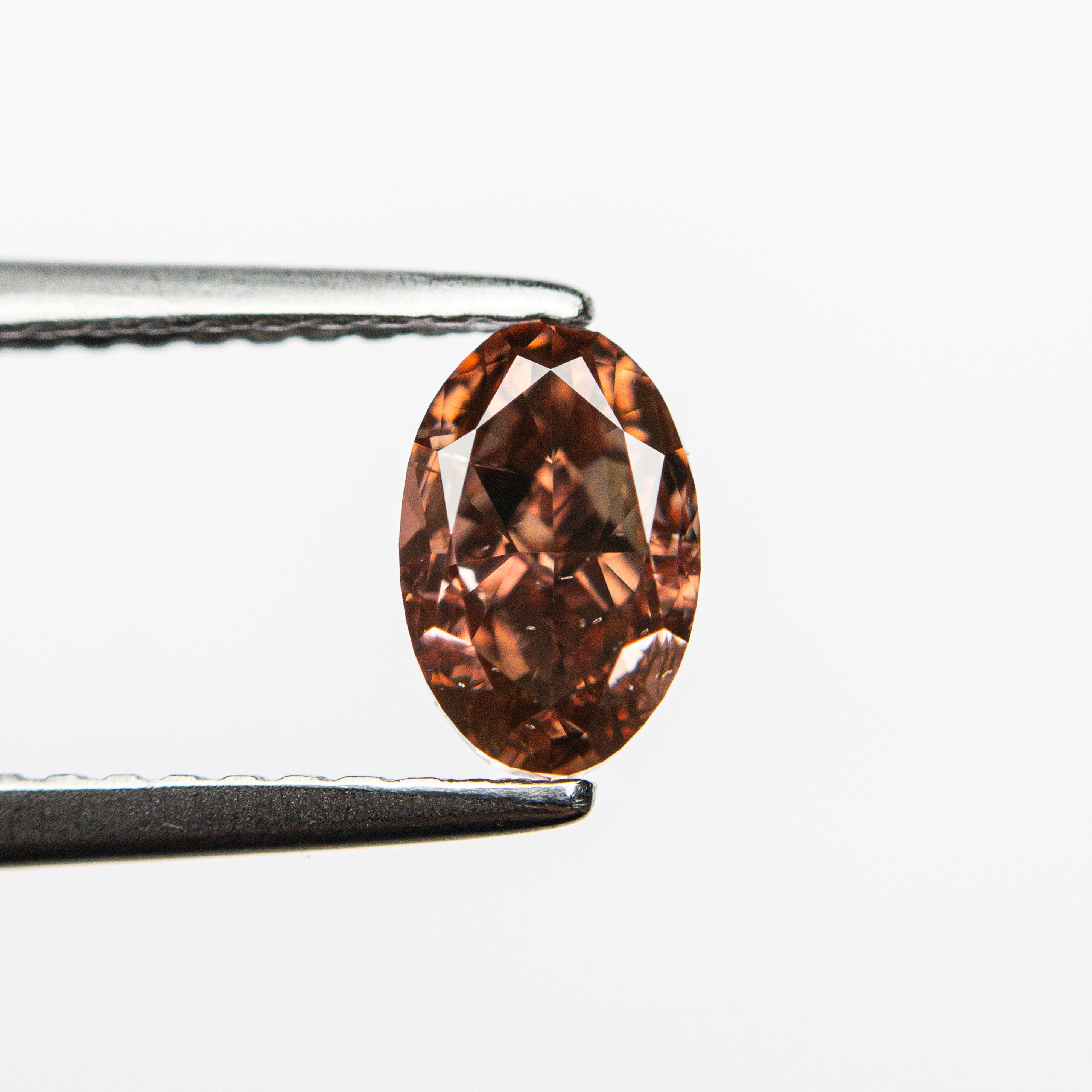 The 0.80ct 6.64x4.33x3.25mm GIA SI2 Fancy Deep Brownish Orangy Pink Oval Brilliant 🇦🇺 24162-01 by East London jeweller Rachel Boston | Discover our collections of unique and timeless engagement rings, wedding rings, and modern fine jewellery.