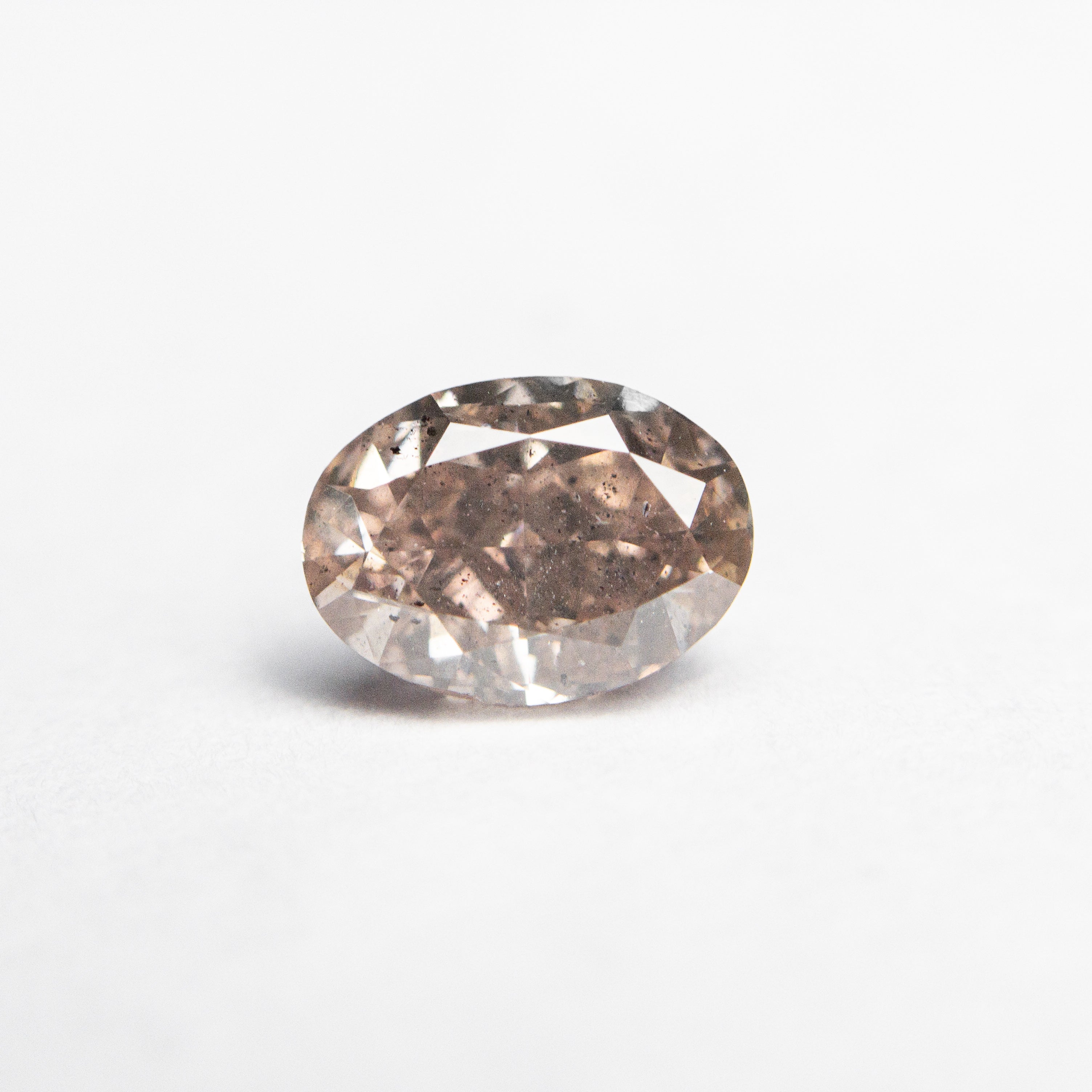 The 0.90ct 6.72x4.87x3.46mm GIA I1 Fancy Pink-Brown Oval Brilliant 🇦🇺 24092-01 by East London jeweller Rachel Boston | Discover our collections of unique and timeless engagement rings, wedding rings, and modern fine jewellery.