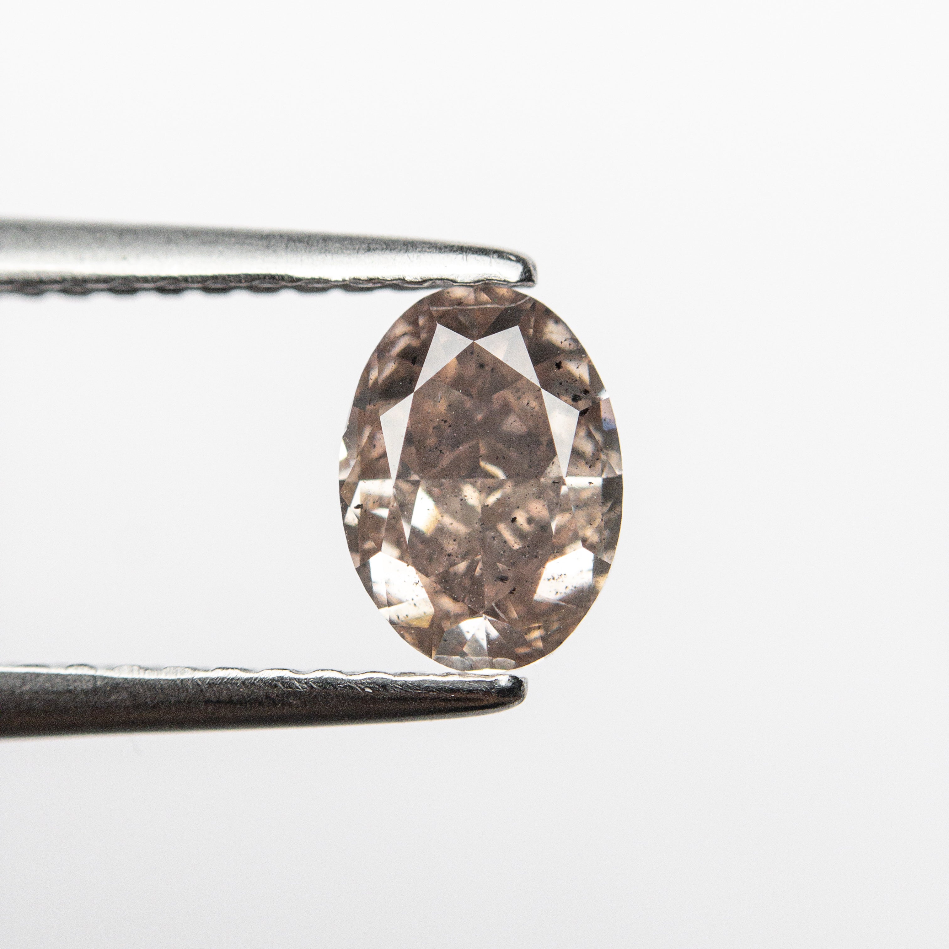The 0.90ct 6.72x4.87x3.46mm GIA I1 Fancy Pink-Brown Oval Brilliant 🇦🇺 24092-01 by East London jeweller Rachel Boston | Discover our collections of unique and timeless engagement rings, wedding rings, and modern fine jewellery.