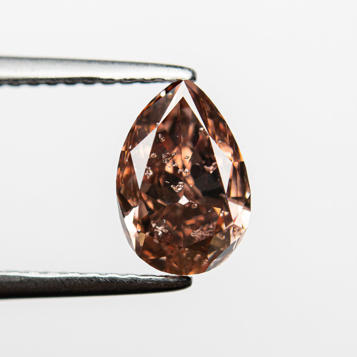 The 1.50ct 8.44x5.77x3.82mm GIA Fancy Deep Orangy Pink Pear Brilliant 🇦🇺 24152-01 by East London jeweller Rachel Boston | Discover our collections of unique and timeless engagement rings, wedding rings, and modern fine jewellery.