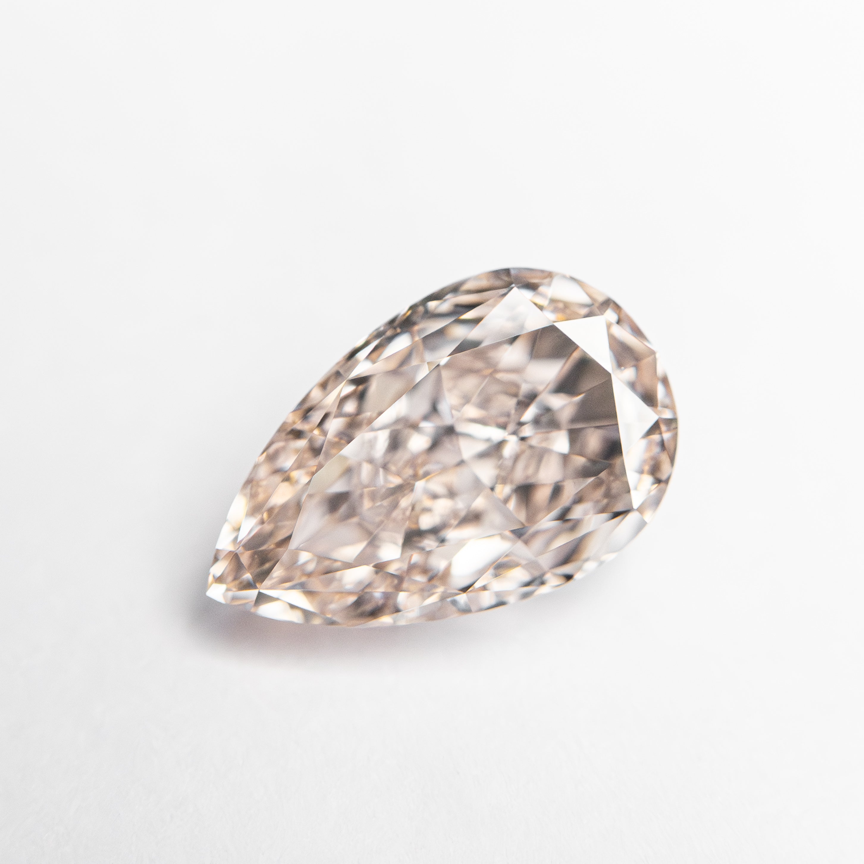 The 1.61ct 9.36x5.89x3.89mm GIA Internally Flawless Fancy Light Brownish Pink Pear Brilliant 24160-01 by East London jeweller Rachel Boston | Discover our collections of unique and timeless engagement rings, wedding rings, and modern fine jewellery.