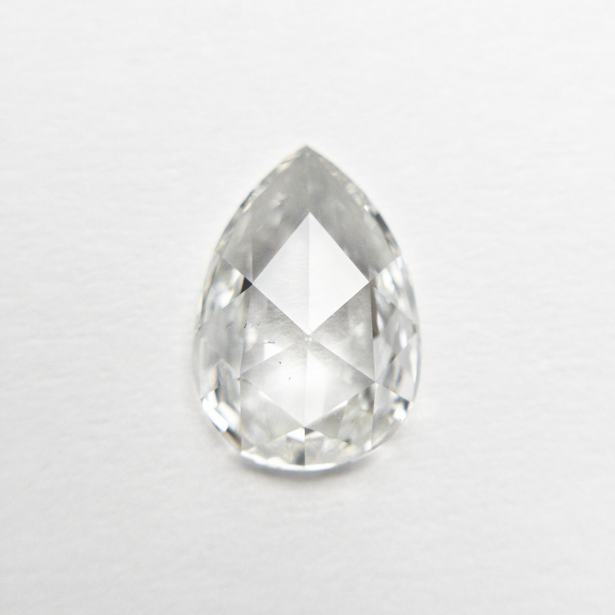The 1.29ct 9.63x6.73x2.74mm SI1 G Pear Rosecut 19643-01 by East London jeweller Rachel Boston | Discover our collections of unique and timeless engagement rings, wedding rings, and modern fine jewellery.