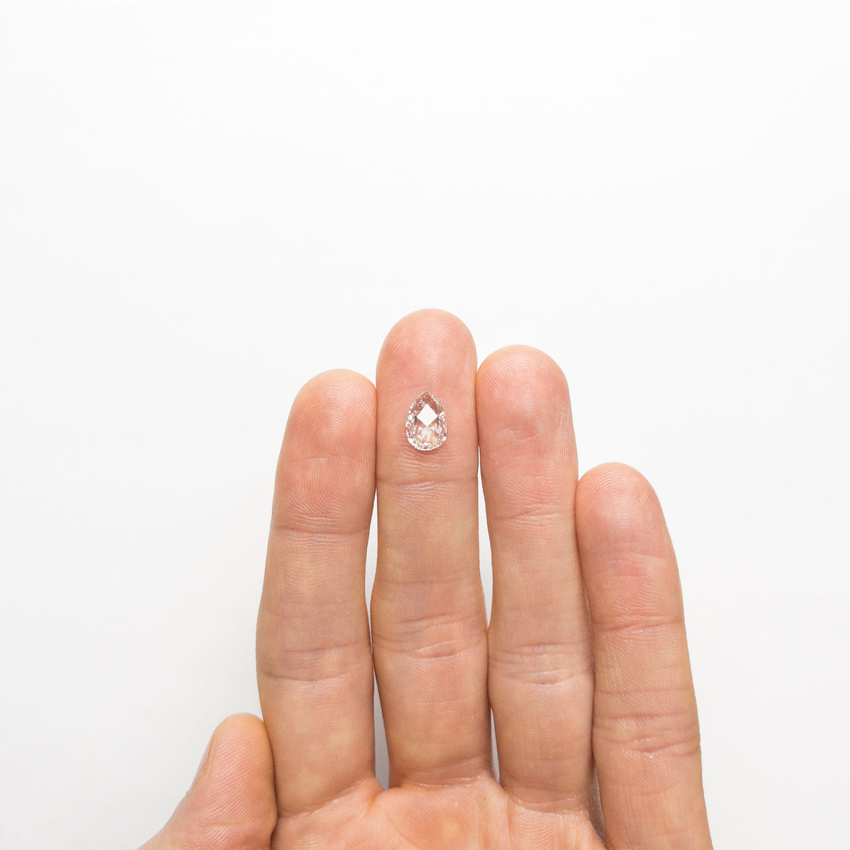 The 1.29ct 9.63x6.73x2.74mm SI1 G Pear Rosecut 19643-01 by East London jeweller Rachel Boston | Discover our collections of unique and timeless engagement rings, wedding rings, and modern fine jewellery.