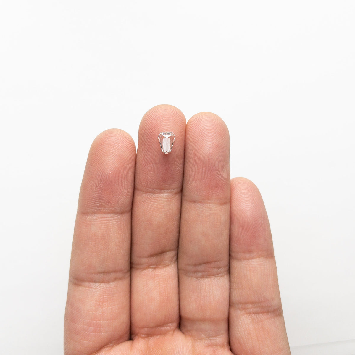 The 0.43ct 6.63x5.17x1.84mm VVS G Shield Step Cut 19655-01 by East London jeweller Rachel Boston | Discover our collections of unique and timeless engagement rings, wedding rings, and modern fine jewellery.