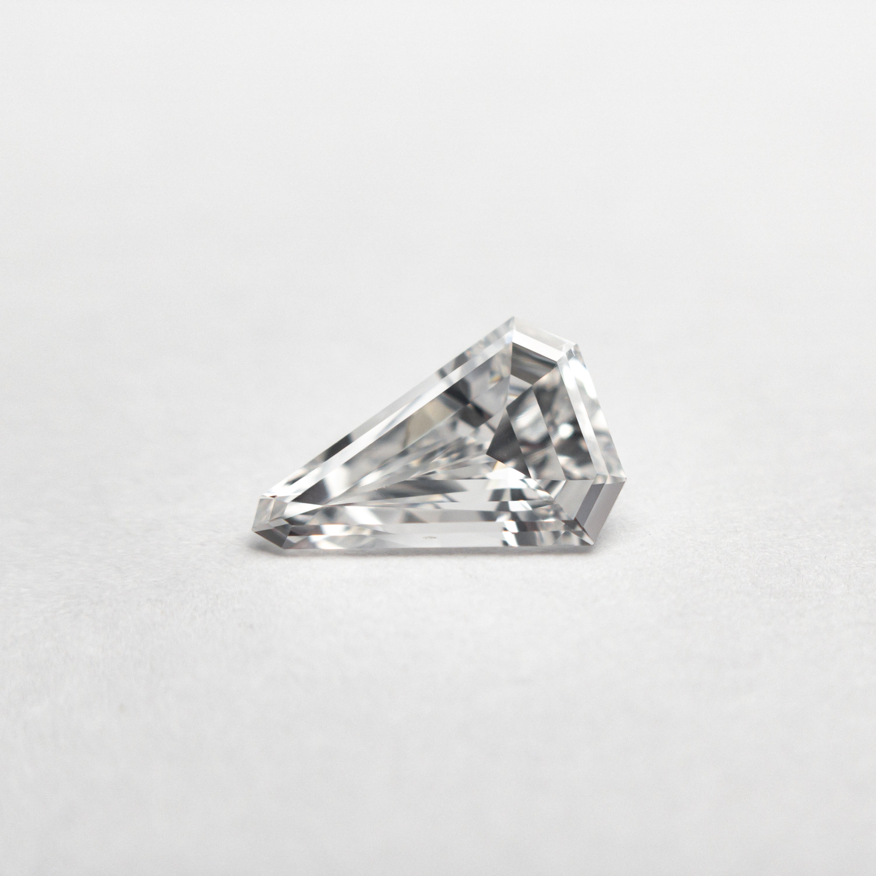 The 0.43ct 7.70x5.11x2.12mm VS2 E Shield Step Cut 19677-02 by East London jeweller Rachel Boston | Discover our collections of unique and timeless engagement rings, wedding rings, and modern fine jewellery.