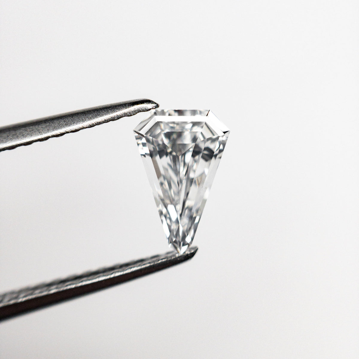 The 0.43ct 7.70x5.11x2.12mm VS2 E Shield Step Cut 19677-02 by East London jeweller Rachel Boston | Discover our collections of unique and timeless engagement rings, wedding rings, and modern fine jewellery.