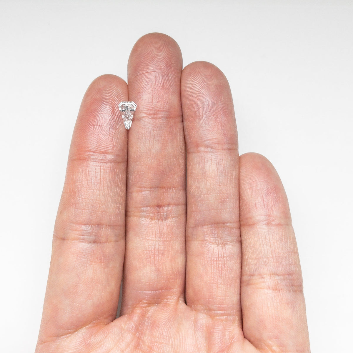The 0.43ct 7.70x5.11x2.12mm VS2 E Shield Step Cut 19677-02 by East London jeweller Rachel Boston | Discover our collections of unique and timeless engagement rings, wedding rings, and modern fine jewellery.