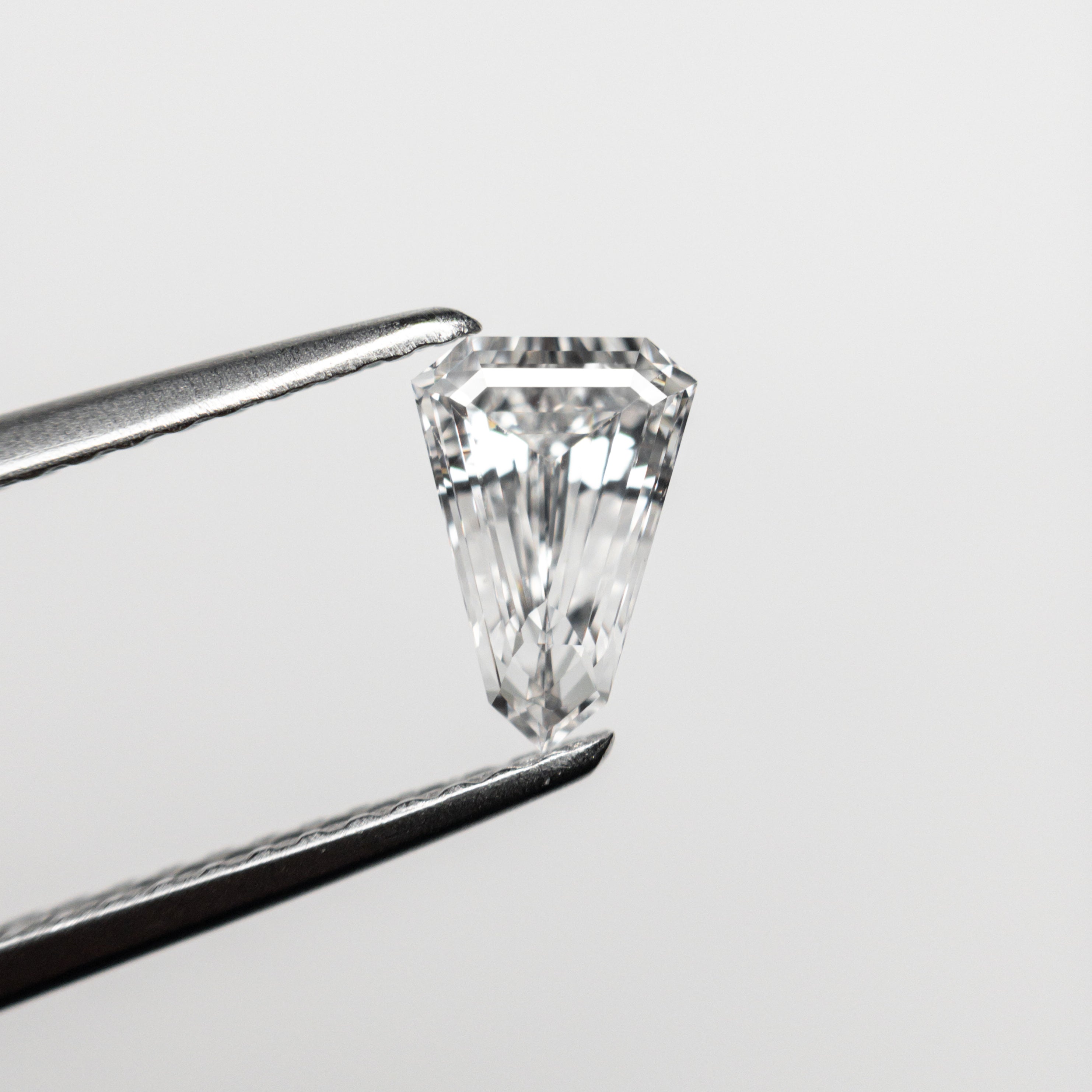 The 0.55ct 7.13x4.85x2.66mm VS2 F Shield Step Cut 19677-03 by East London jeweller Rachel Boston | Discover our collections of unique and timeless engagement rings, wedding rings, and modern fine jewellery.