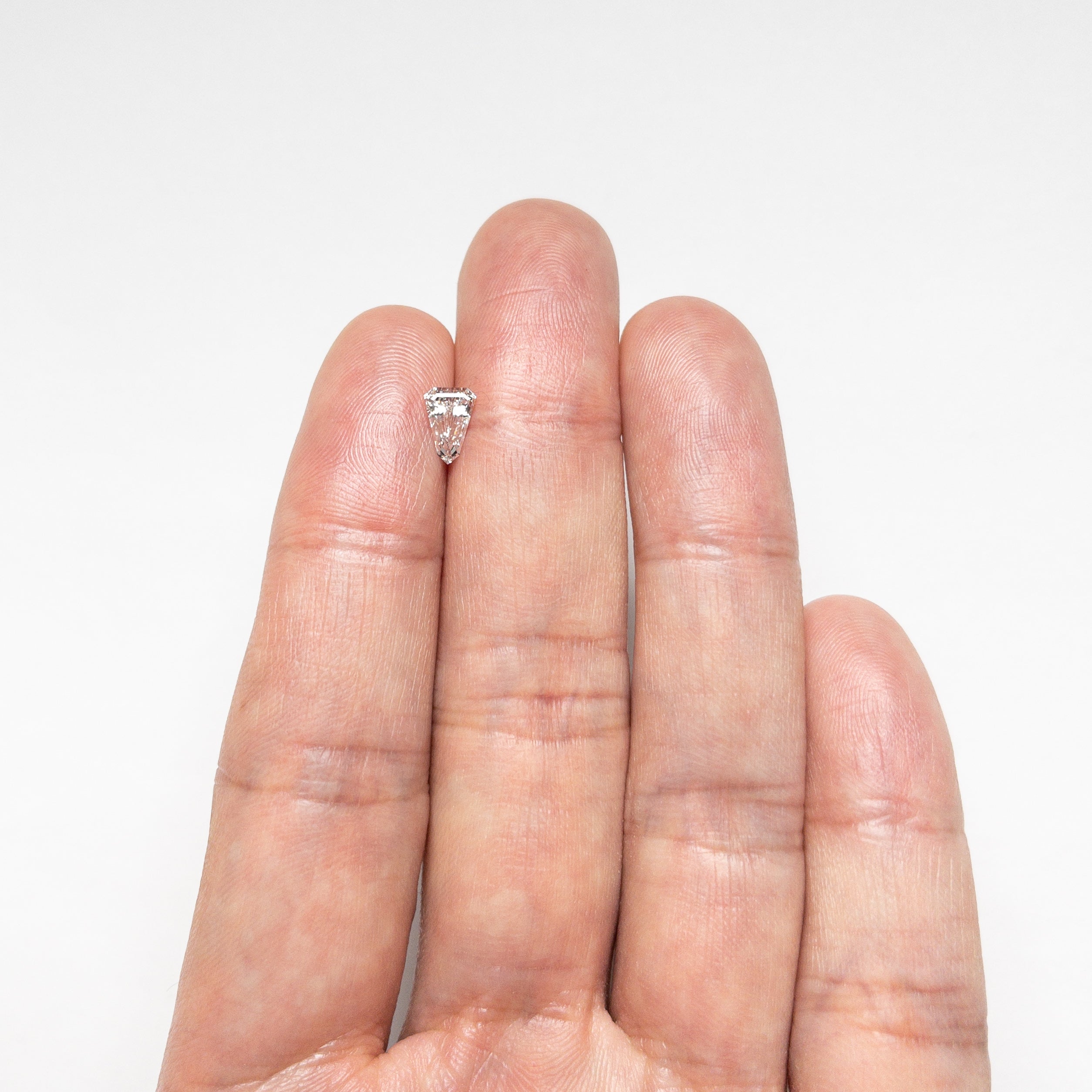The 0.55ct 7.13x4.85x2.66mm VS2 F Shield Step Cut 19677-03 by East London jeweller Rachel Boston | Discover our collections of unique and timeless engagement rings, wedding rings, and modern fine jewellery.