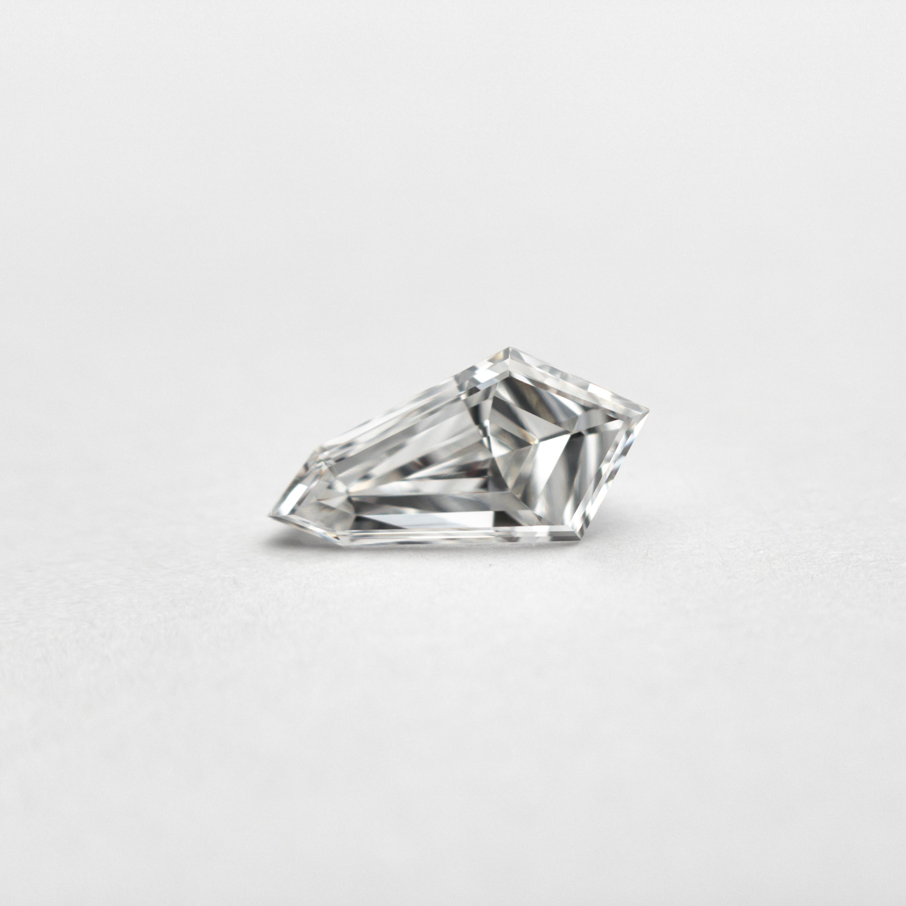 The 0.58ct 8.20x4.25x3.15mm VS2 F Kite Step Cut 19677-05 by East London jeweller Rachel Boston | Discover our collections of unique and timeless engagement rings, wedding rings, and modern fine jewellery.