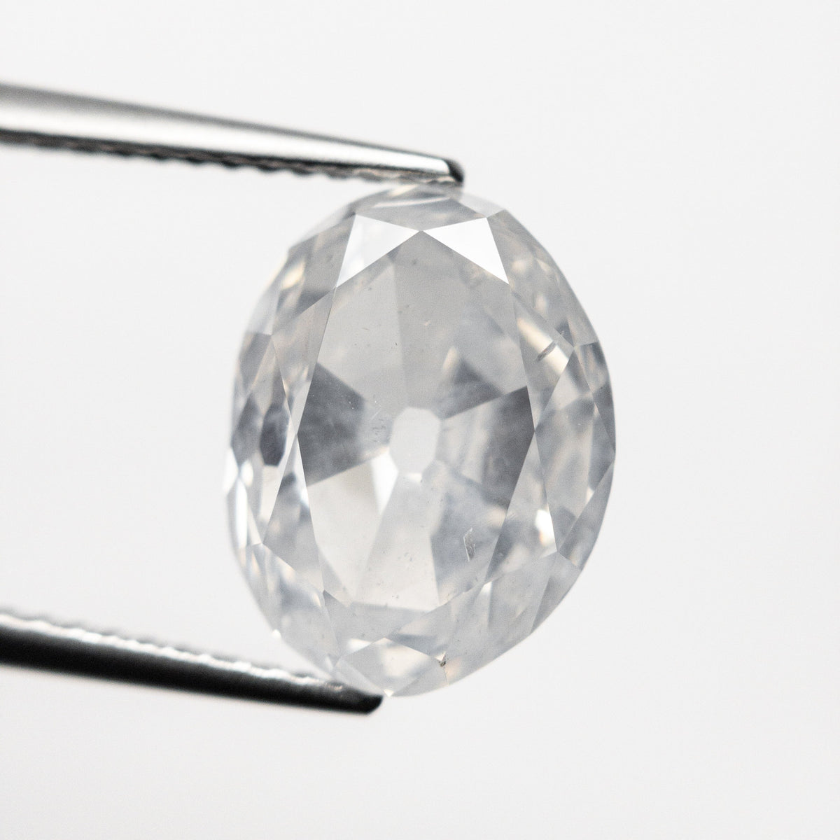 The 5.54ct 11.83x9.02x6.02mm GIA I2 Fancy White Modern Antique Oval Old Mine Cut 19722-01 by East London jeweller Rachel Boston | Discover our collections of unique and timeless engagement rings, wedding rings, and modern fine jewellery.