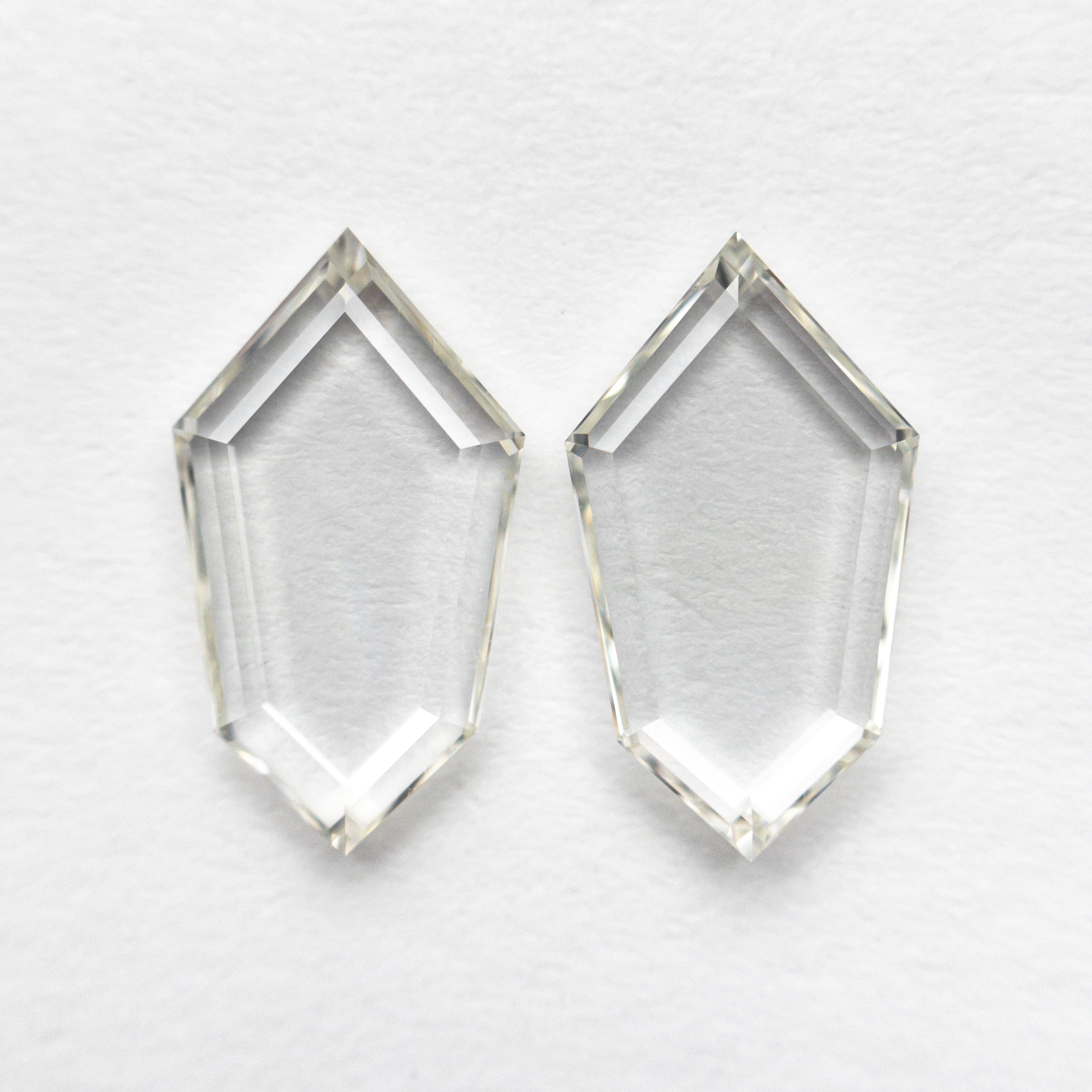 The 1.85cttw 2pc 10.34x5.80x1.54mm 10.30x5.78x1.58mm VS J-K Shield Portrait Cut Matching Pair 19854-49 by East London jeweller Rachel Boston | Discover our collections of unique and timeless engagement rings, wedding rings, and modern fine jewellery.