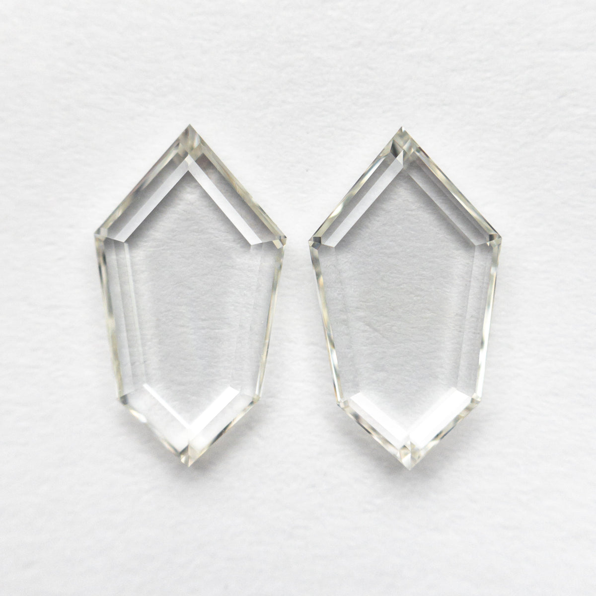 The 1.85cttw 2pc 10.34x5.80x1.54mm 10.30x5.78x1.58mm VS J-K Shield Portrait Cut Matching Pair 19854-49 by East London jeweller Rachel Boston | Discover our collections of unique and timeless engagement rings, wedding rings, and modern fine jewellery.