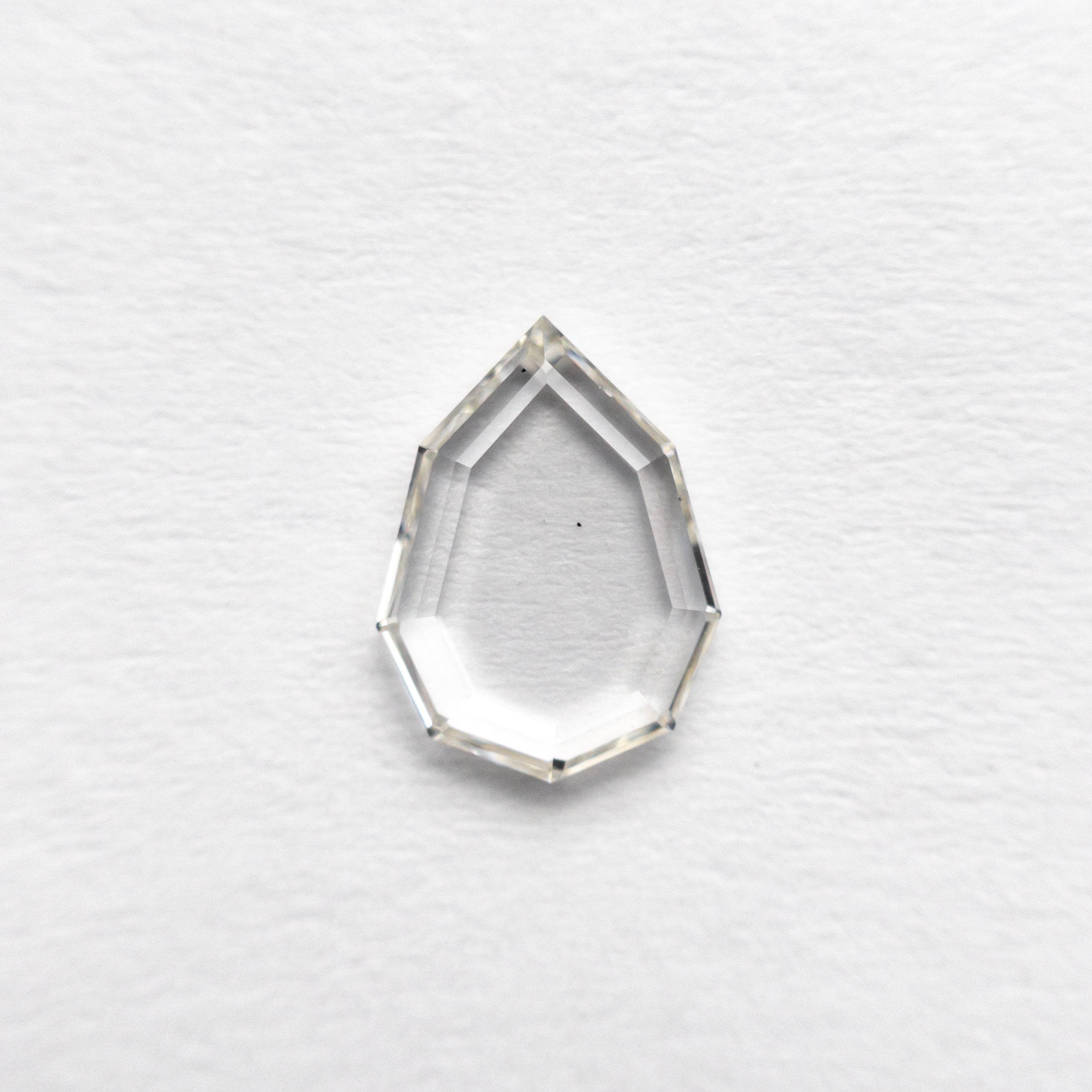 The 0.63ct 7.73x5.73x1.41mm Geo Pear Portrait Cut 19854-54 by East London jeweller Rachel Boston | Discover our collections of unique and timeless engagement rings, wedding rings, and modern fine jewellery.