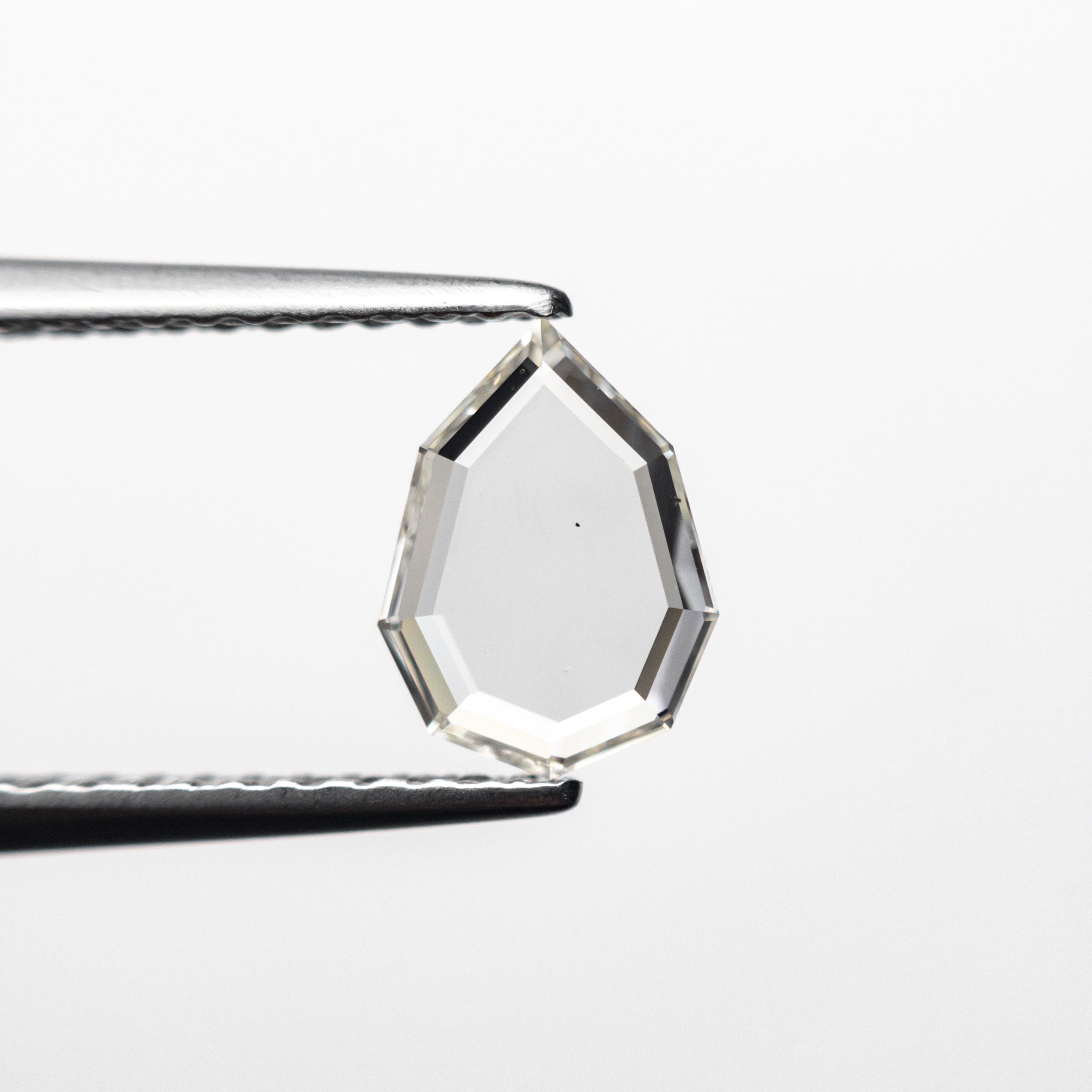 The 0.63ct 7.73x5.73x1.41mm Geo Pear Portrait Cut 19854-54 by East London jeweller Rachel Boston | Discover our collections of unique and timeless engagement rings, wedding rings, and modern fine jewellery.