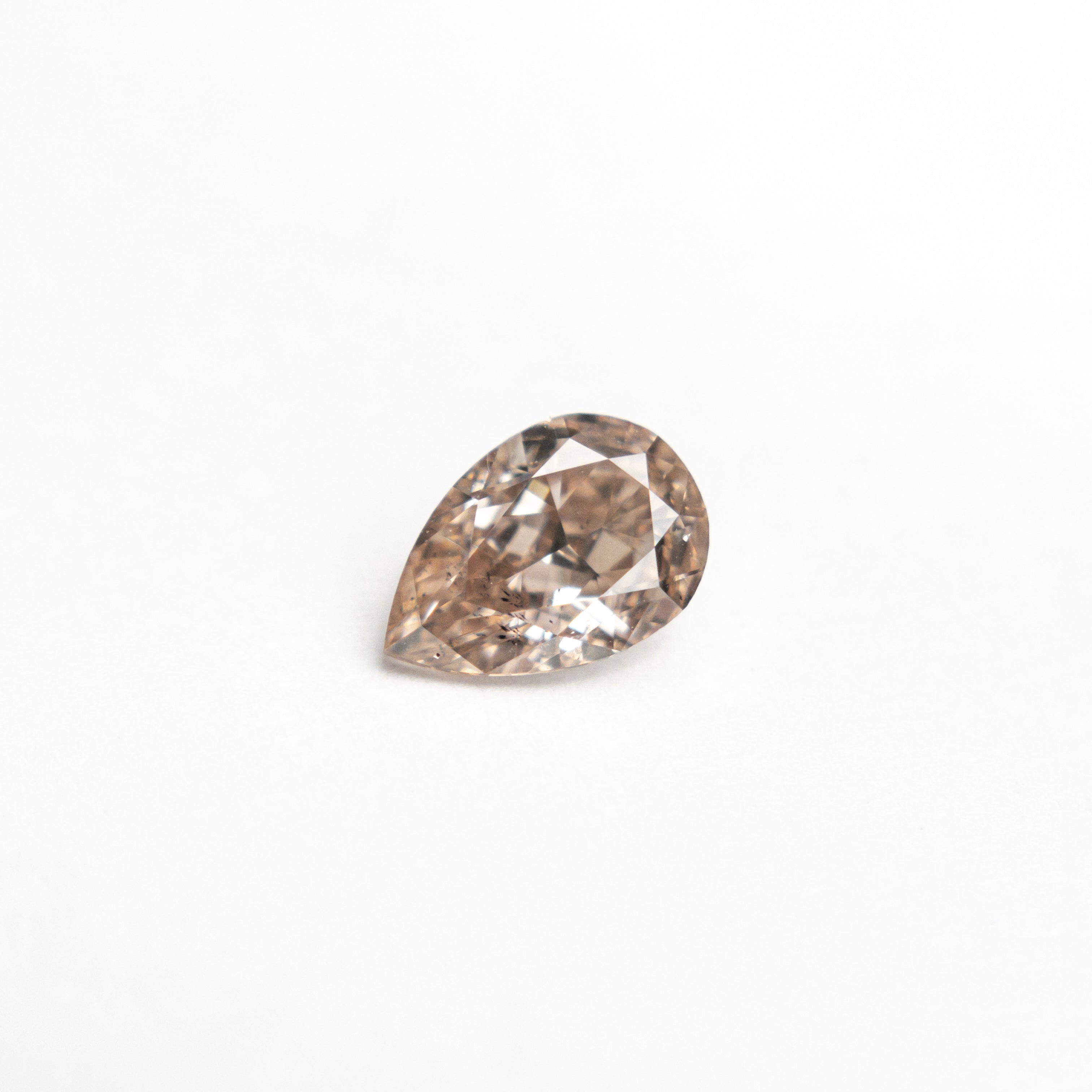 The 0.45ct 6.05x4.10x2.54mm SI2 Fancy Brownish Pink Pear Brilliant 19920-01 by East London jeweller Rachel Boston | Discover our collections of unique and timeless engagement rings, wedding rings, and modern fine jewellery.