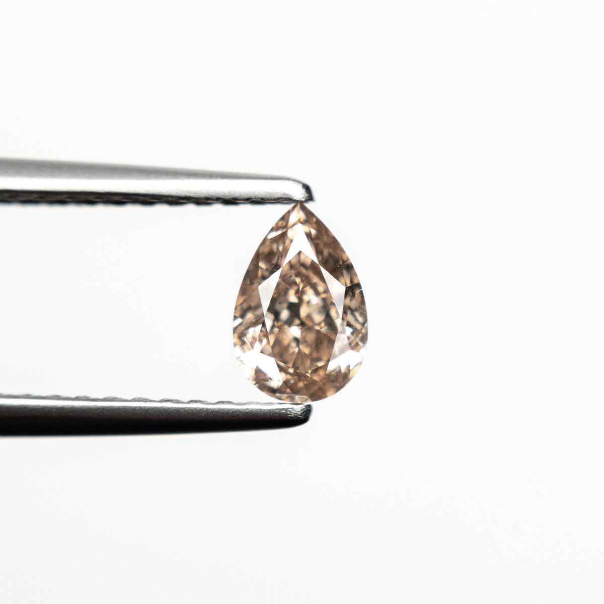 The 0.45ct 6.05x4.10x2.54mm SI2 Fancy Brownish Pink Pear Brilliant 19920-01 by East London jeweller Rachel Boston | Discover our collections of unique and timeless engagement rings, wedding rings, and modern fine jewellery.
