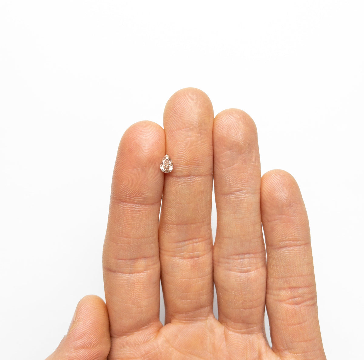 The 0.45ct 6.05x4.10x2.54mm SI2 Fancy Brownish Pink Pear Brilliant 19920-01 by East London jeweller Rachel Boston | Discover our collections of unique and timeless engagement rings, wedding rings, and modern fine jewellery.