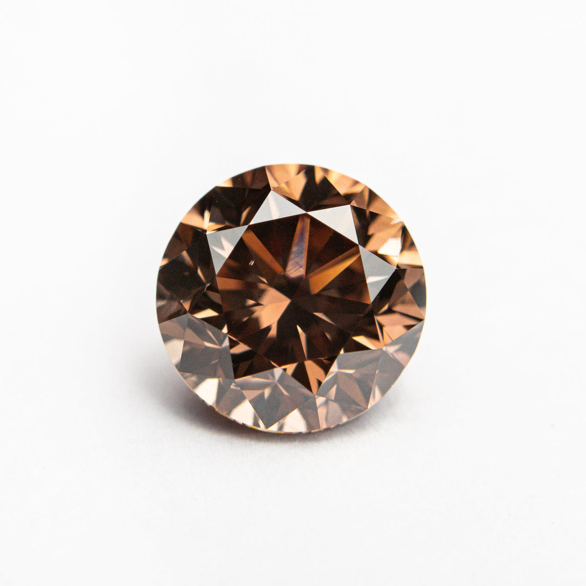 The 2.00ct 7.51x7.42x5.32mm GIA VS2 Fancy Deep Pink-Brown Round Brilliant 🇦🇺 24165-01 by East London jeweller Rachel Boston | Discover our collections of unique and timeless engagement rings, wedding rings, and modern fine jewellery.