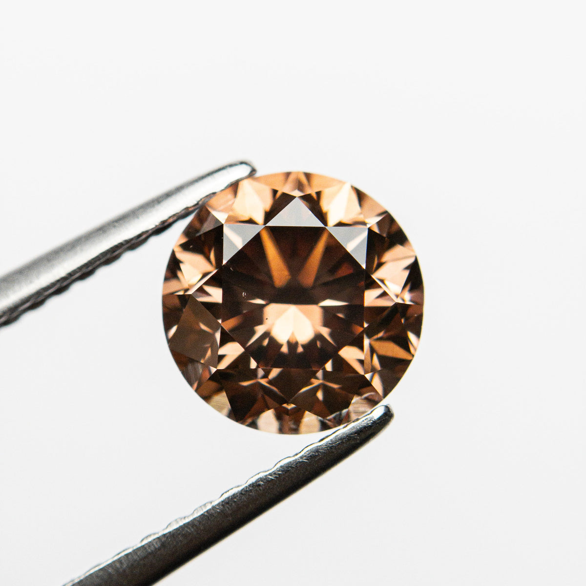 The 2.00ct 7.51x7.42x5.32mm GIA VS2 Fancy Deep Pink-Brown Round Brilliant 🇦🇺 24165-01 by East London jeweller Rachel Boston | Discover our collections of unique and timeless engagement rings, wedding rings, and modern fine jewellery.