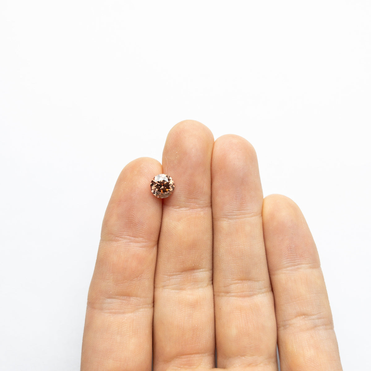 The 2.00ct 7.51x7.42x5.32mm GIA VS2 Fancy Deep Pink-Brown Round Brilliant 🇦🇺 24165-01 by East London jeweller Rachel Boston | Discover our collections of unique and timeless engagement rings, wedding rings, and modern fine jewellery.