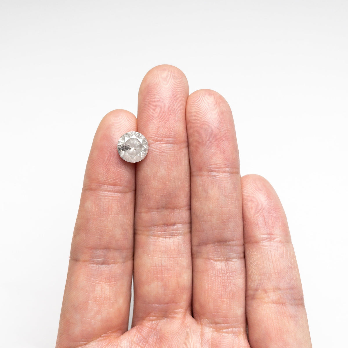The 3.31ct 9.21x9.19x6.01mm Round Brilliant 20025-05 by East London jeweller Rachel Boston | Discover our collections of unique and timeless engagement rings, wedding rings, and modern fine jewellery.