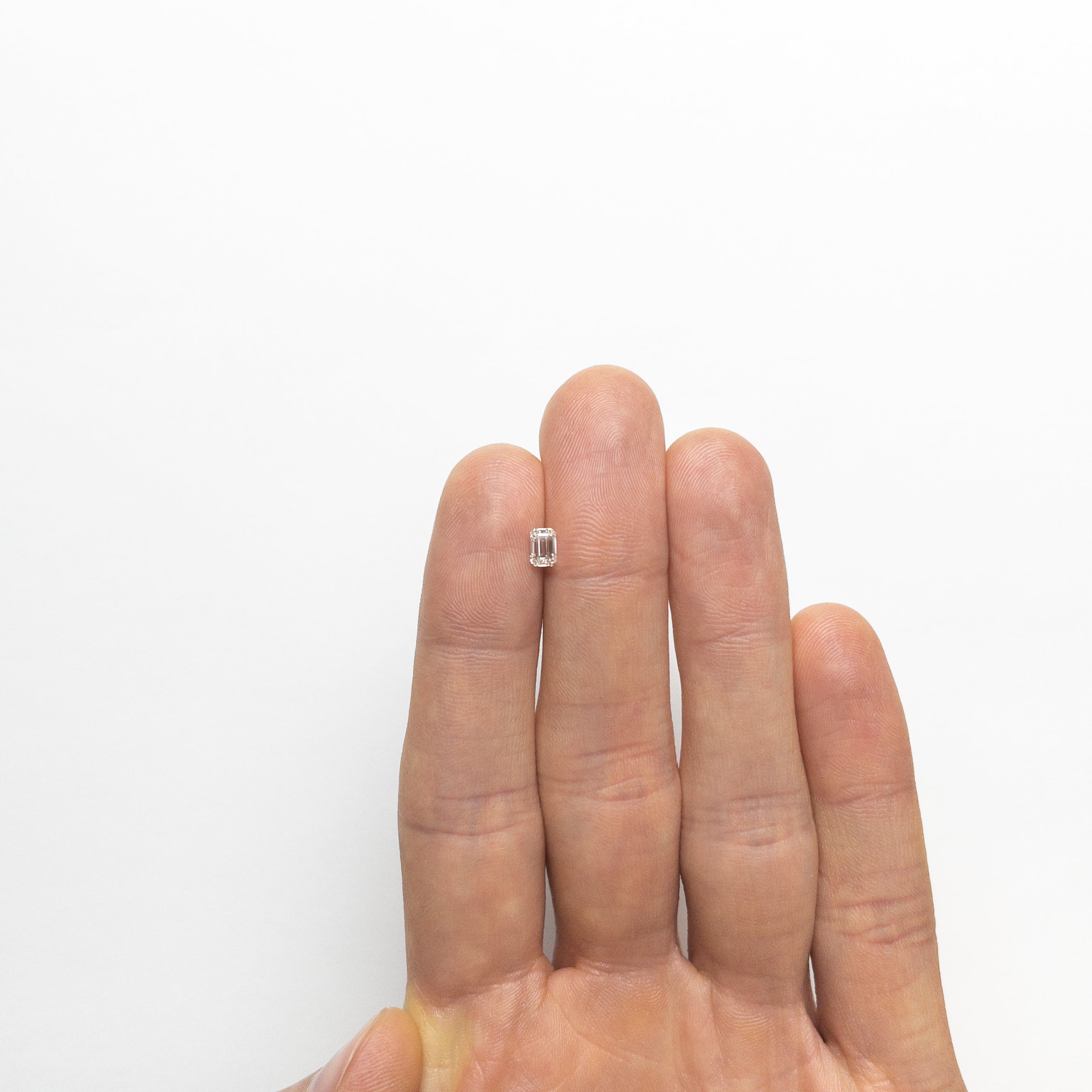 The 0.45ct 4.94x3.46x2.45mm VVS G Cut Corner Rectangle Step Cut 🇨🇦 21345-01 by East London jeweller Rachel Boston | Discover our collections of unique and timeless engagement rings, wedding rings, and modern fine jewellery.