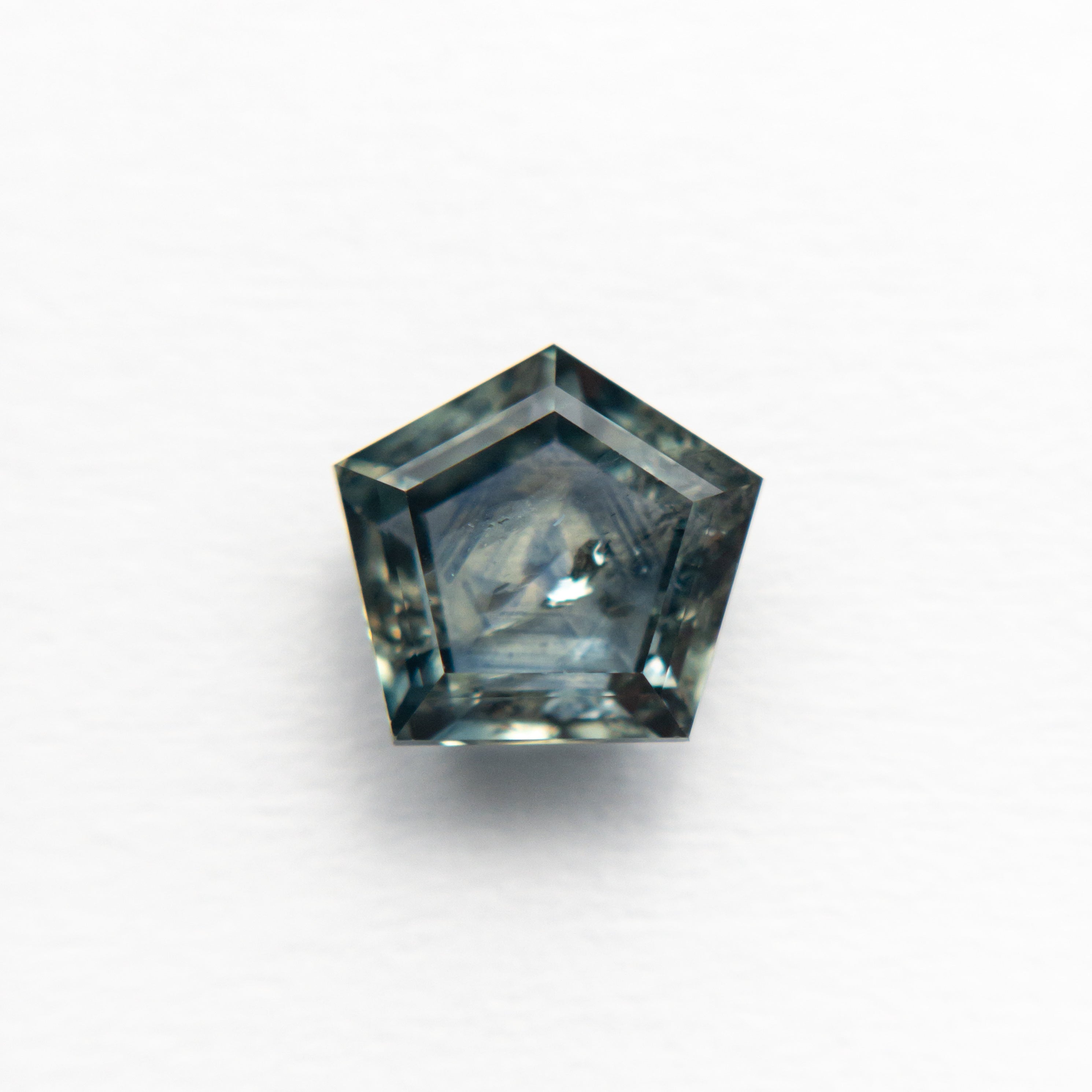 The 1.72ct 7.16x6.63x3.43mm Pentagon Double Cut Sapphire 21592-10 by East London jeweller Rachel Boston | Discover our collections of unique and timeless engagement rings, wedding rings, and modern fine jewellery.