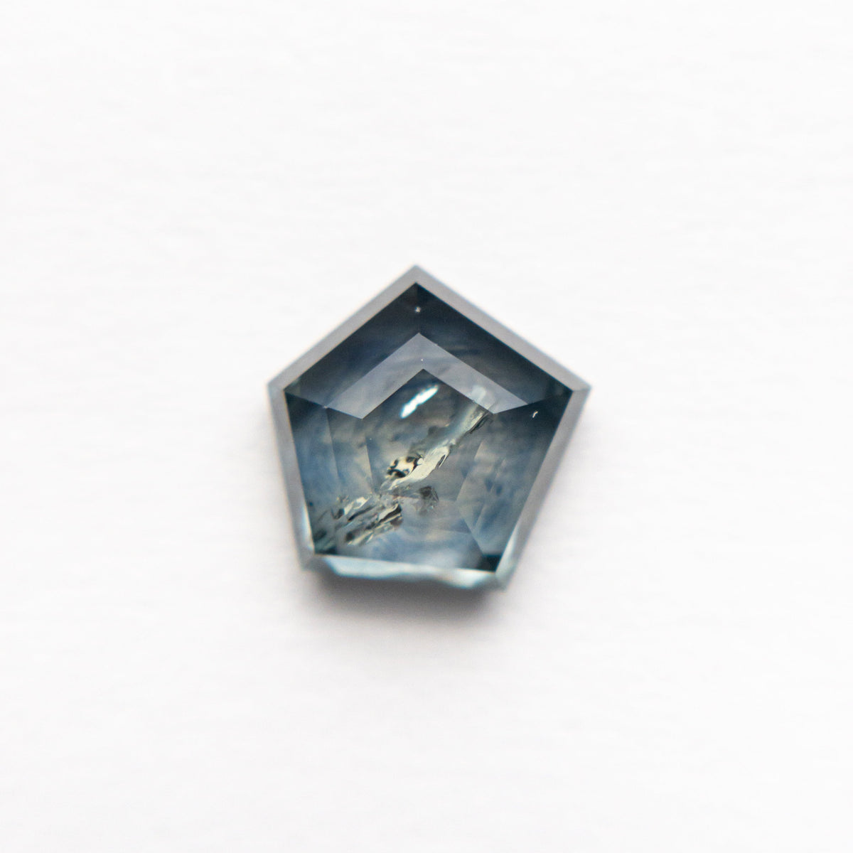 The 1.72ct 7.16x6.63x3.43mm Pentagon Double Cut Sapphire 21592-10 by East London jeweller Rachel Boston | Discover our collections of unique and timeless engagement rings, wedding rings, and modern fine jewellery.