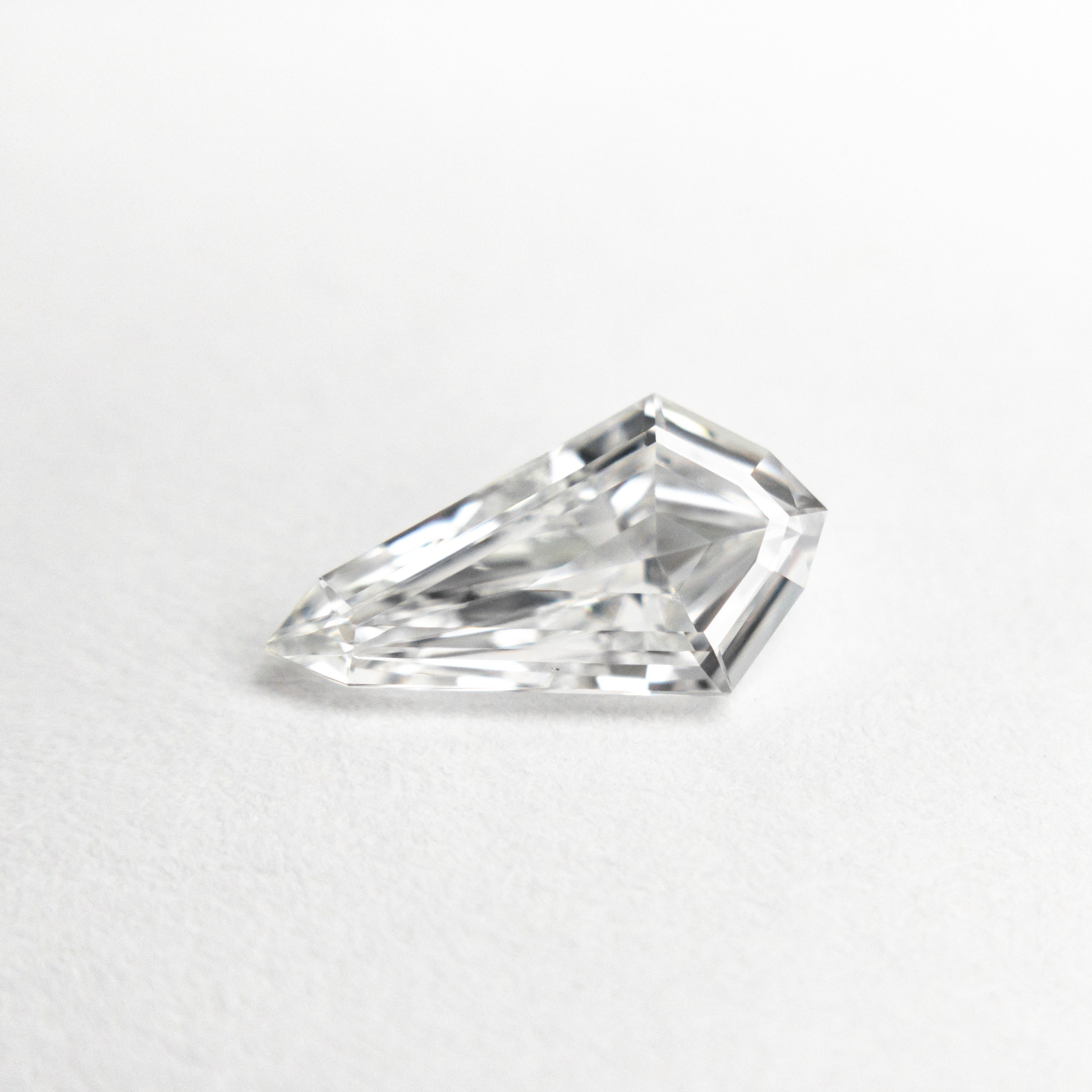 The 0.72ct 9.53x5.13x2.32mm SI1 D Kite Step Cut 21690-01 by East London jeweller Rachel Boston | Discover our collections of unique and timeless engagement rings, wedding rings, and modern fine jewellery.