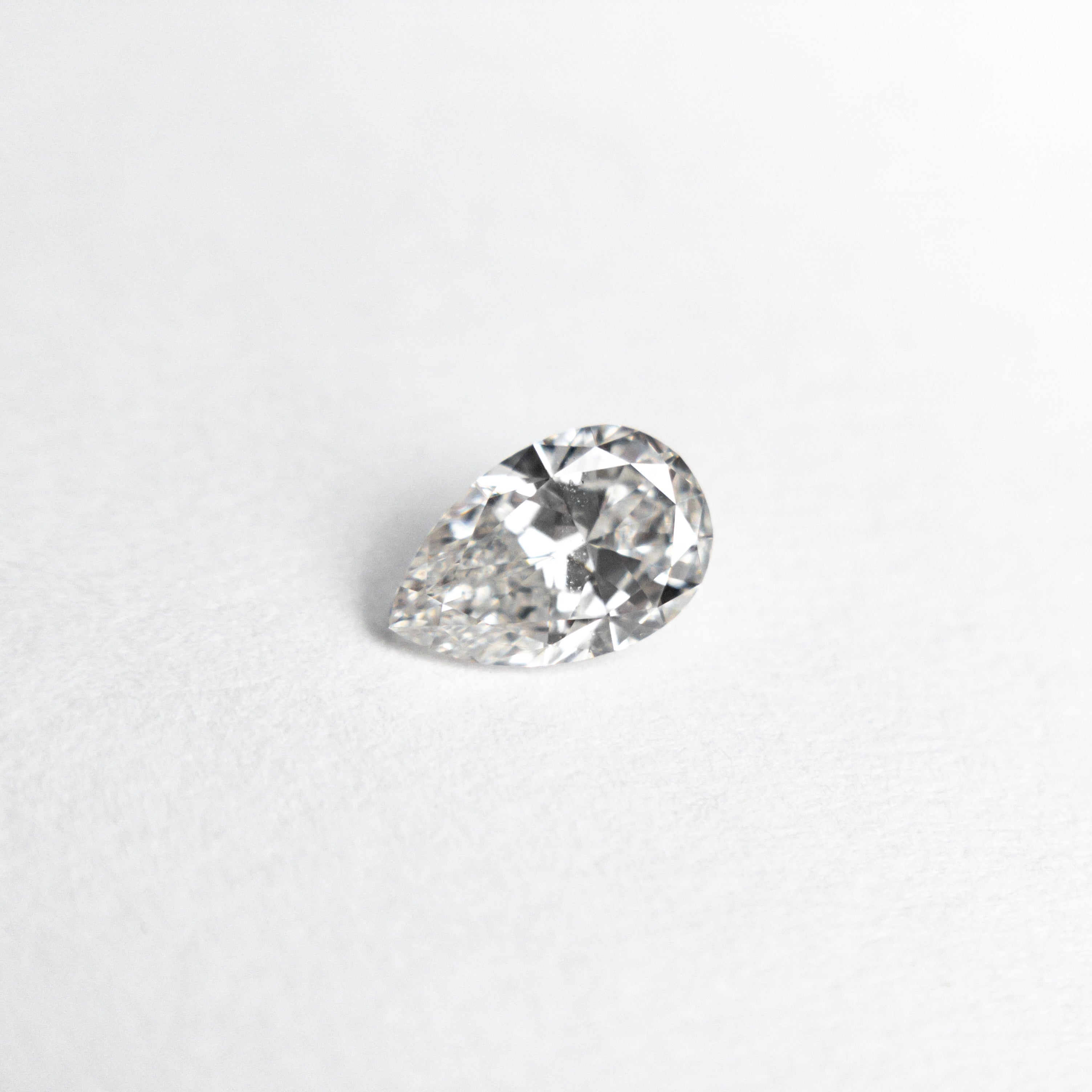 The 0.31ct 5.78x3.75x2.22mm SI1 E Pear Brilliant 🇨🇦 21912-03 by East London jeweller Rachel Boston | Discover our collections of unique and timeless engagement rings, wedding rings, and modern fine jewellery.