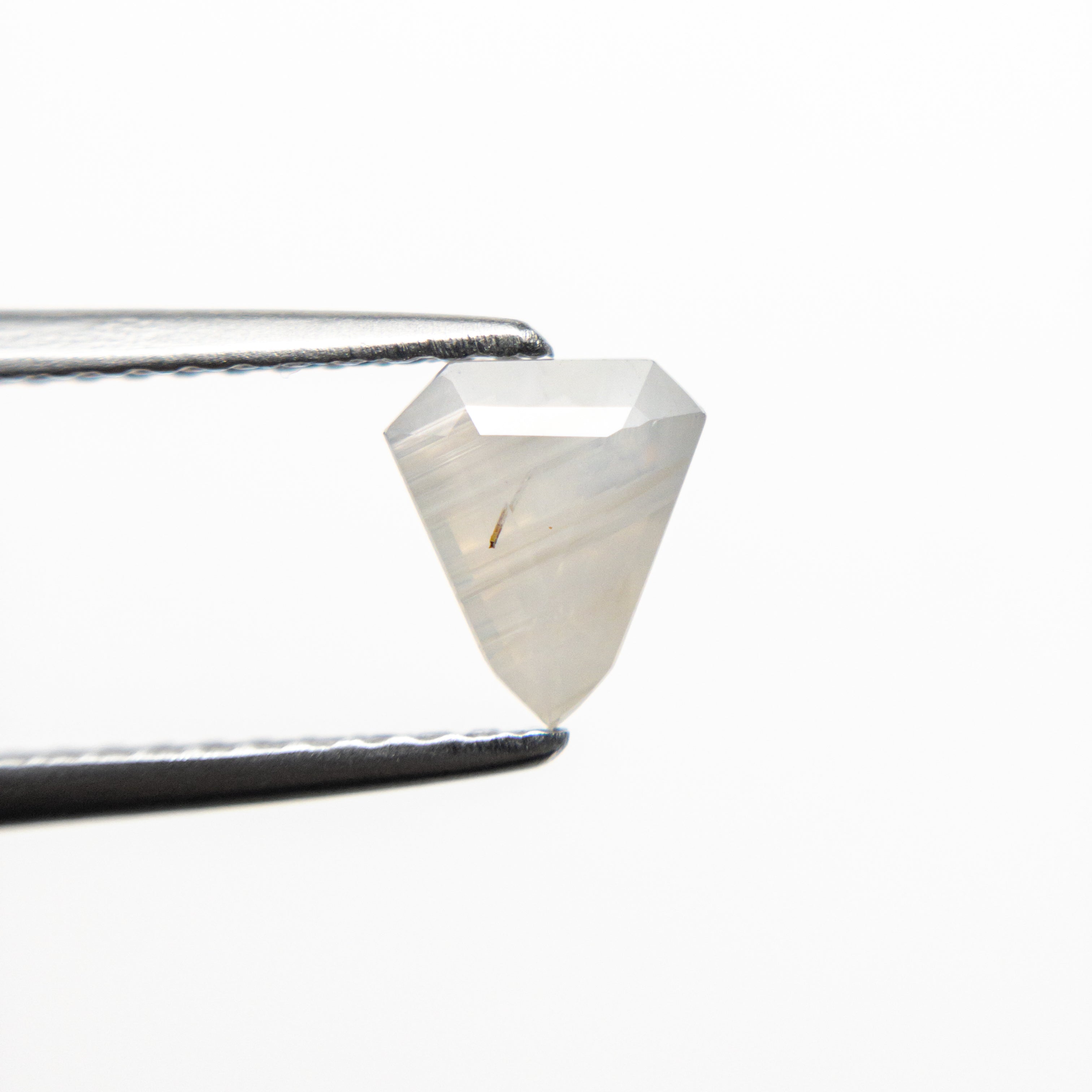 The 0.68ct 6.17x5.37x3.17mm Shield Step Cut Sapphire 21990-01 by East London jeweller Rachel Boston | Discover our collections of unique and timeless engagement rings, wedding rings, and modern fine jewellery.