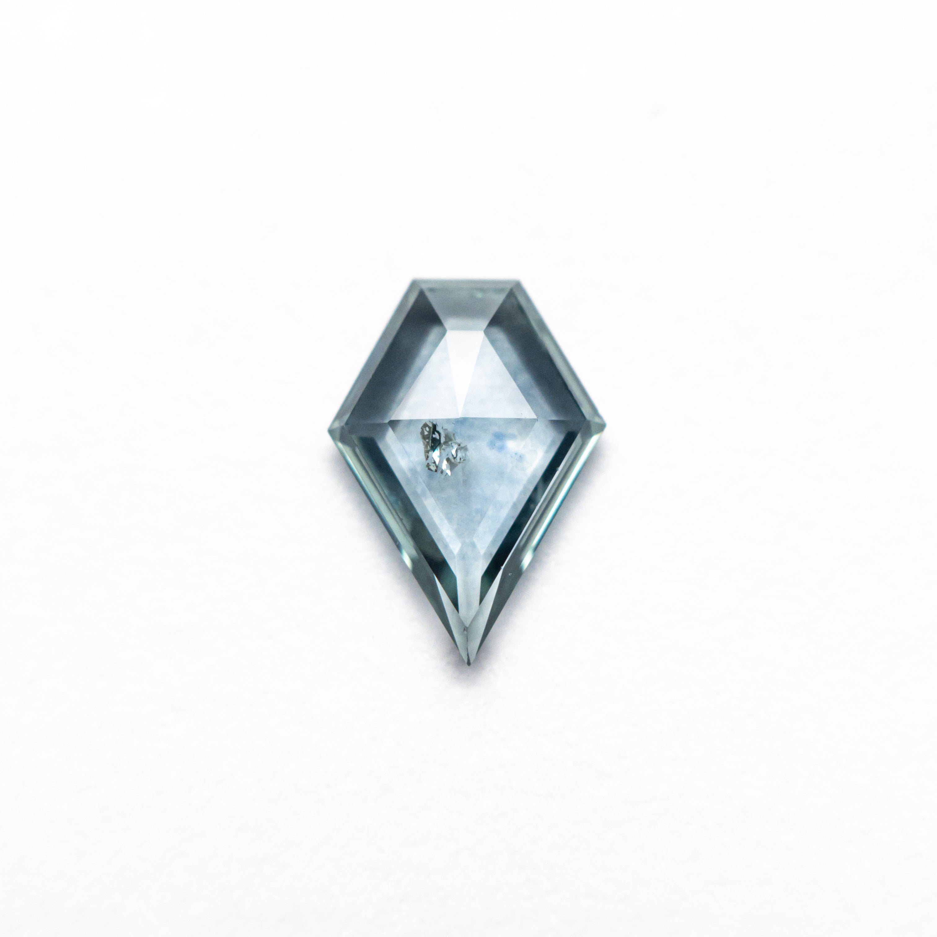 The 0.66ct 7.91x5.59x1.86mm Shield Rosecut Sapphire 22266-32 by East London jeweller Rachel Boston | Discover our collections of unique and timeless engagement rings, wedding rings, and modern fine jewellery.