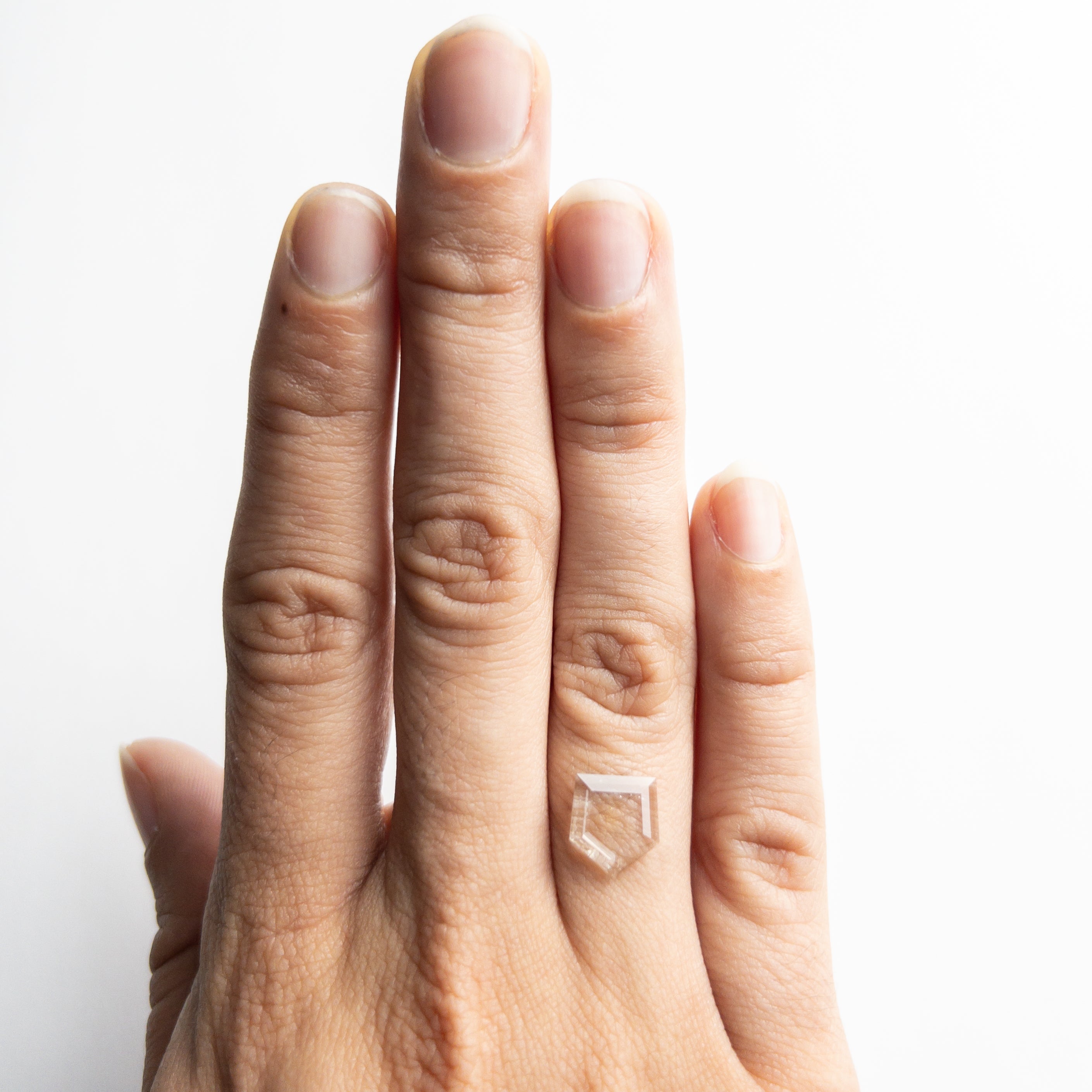 The 1.00ct 9.65x8.90x0.99mm Shield Portrait Cut Sapphire 22392-01 by East London jeweller Rachel Boston | Discover our collections of unique and timeless engagement rings, wedding rings, and modern fine jewellery.