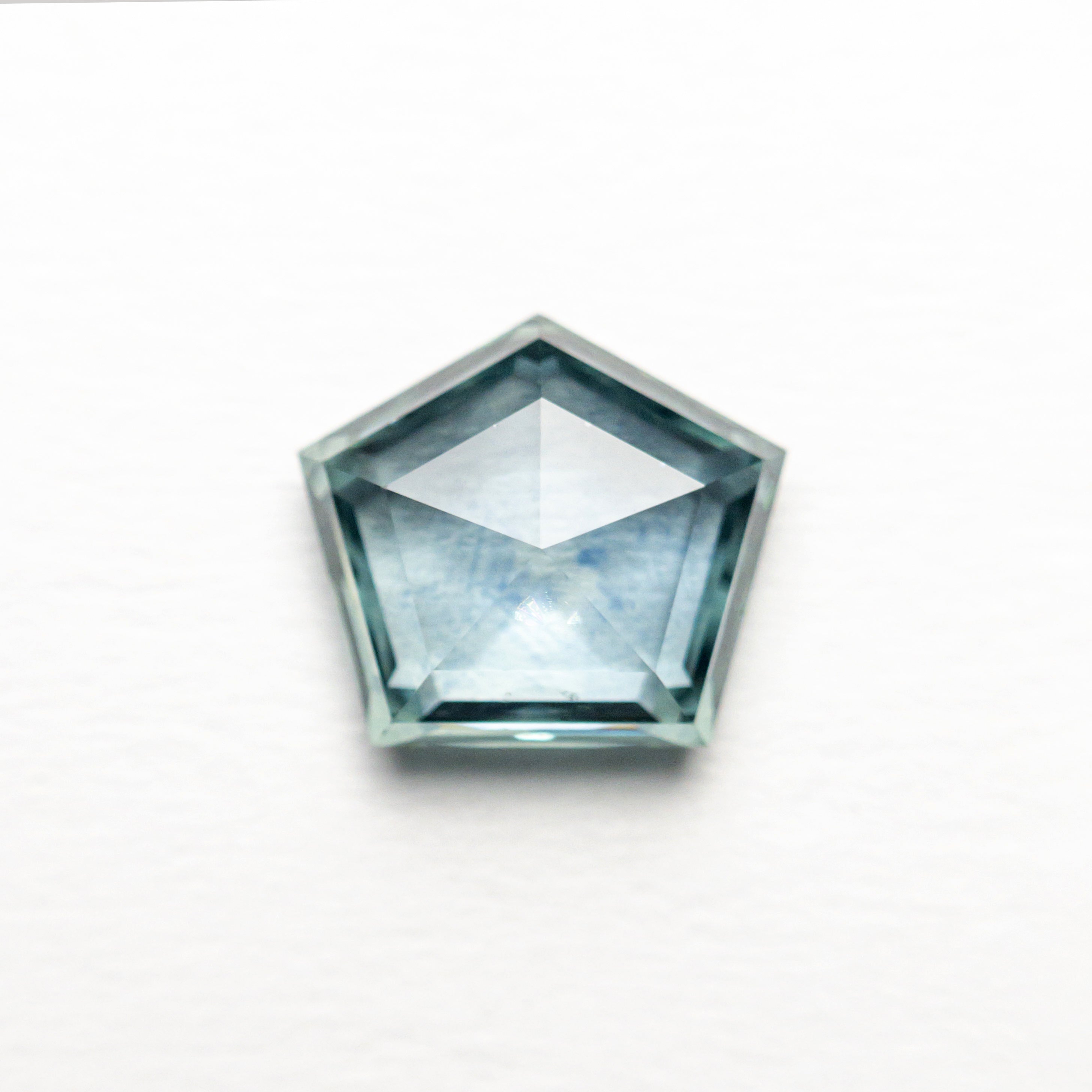 The 1.29ct 7.37x6.51x2.81mm Pentagon Double Cut Sapphire 22434-57 by East London jeweller Rachel Boston | Discover our collections of unique and timeless engagement rings, wedding rings, and modern fine jewellery.