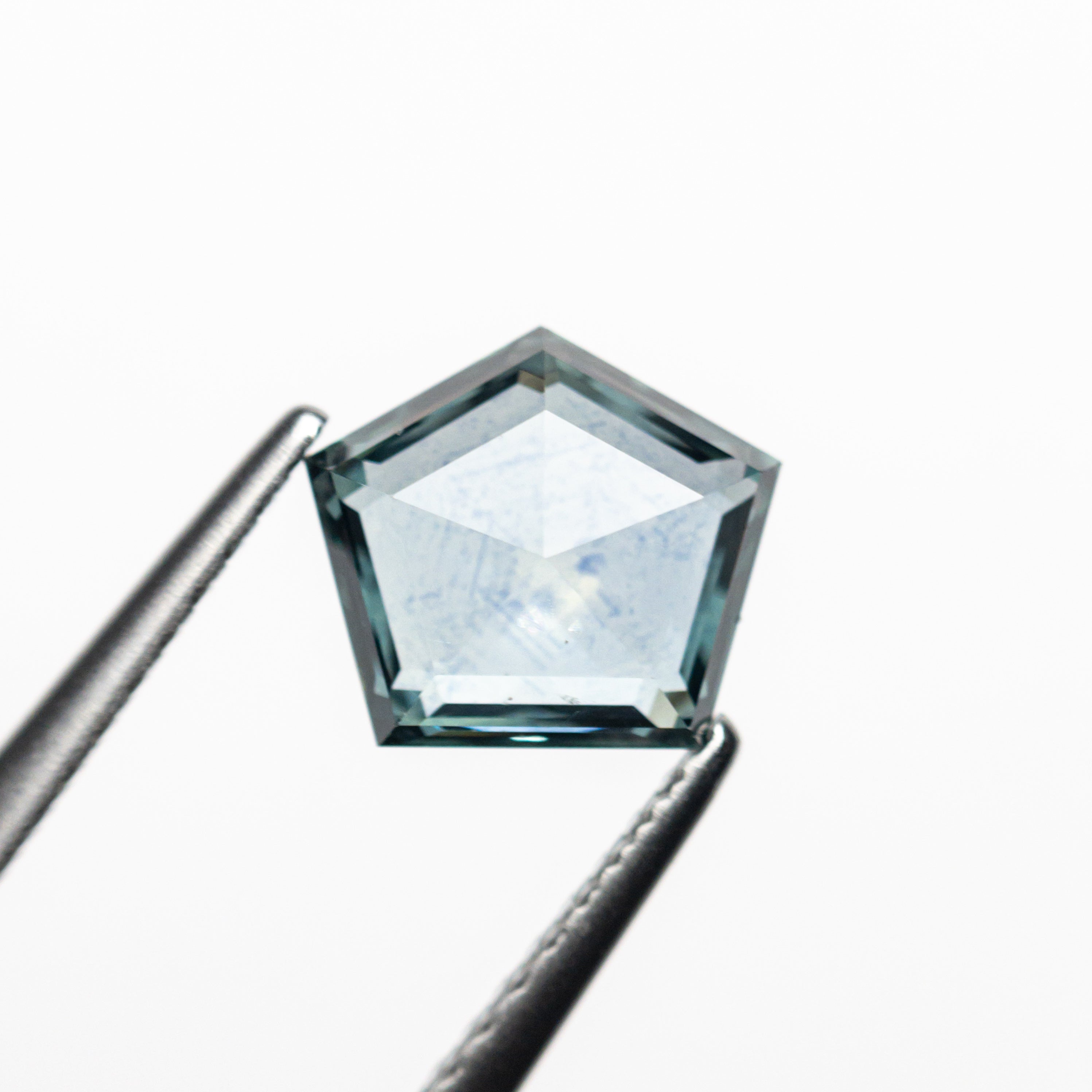 The 1.29ct 7.37x6.51x2.81mm Pentagon Double Cut Sapphire 22434-57 by East London jeweller Rachel Boston | Discover our collections of unique and timeless engagement rings, wedding rings, and modern fine jewellery.