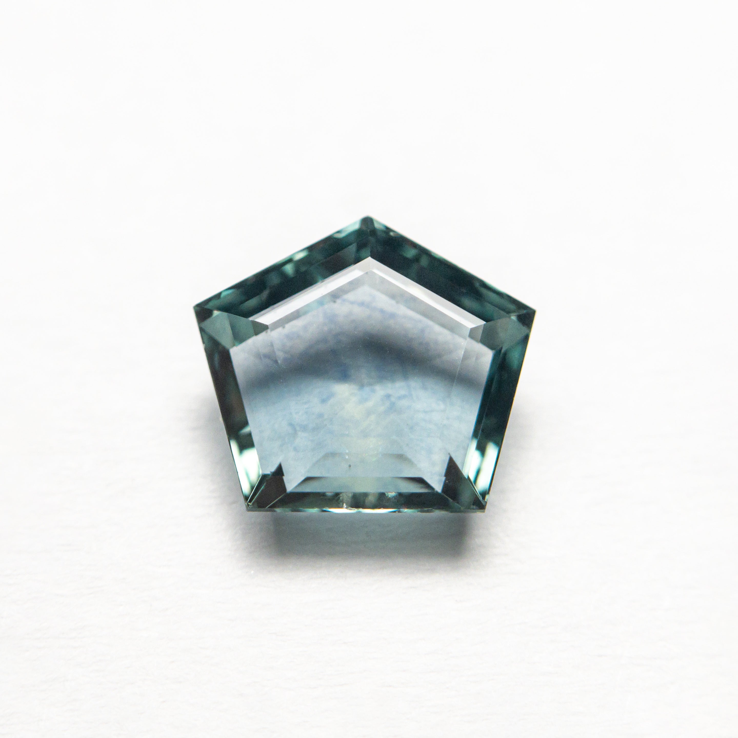 The 1.29ct 7.37x6.51x2.81mm Pentagon Double Cut Sapphire 22434-57 by East London jeweller Rachel Boston | Discover our collections of unique and timeless engagement rings, wedding rings, and modern fine jewellery.