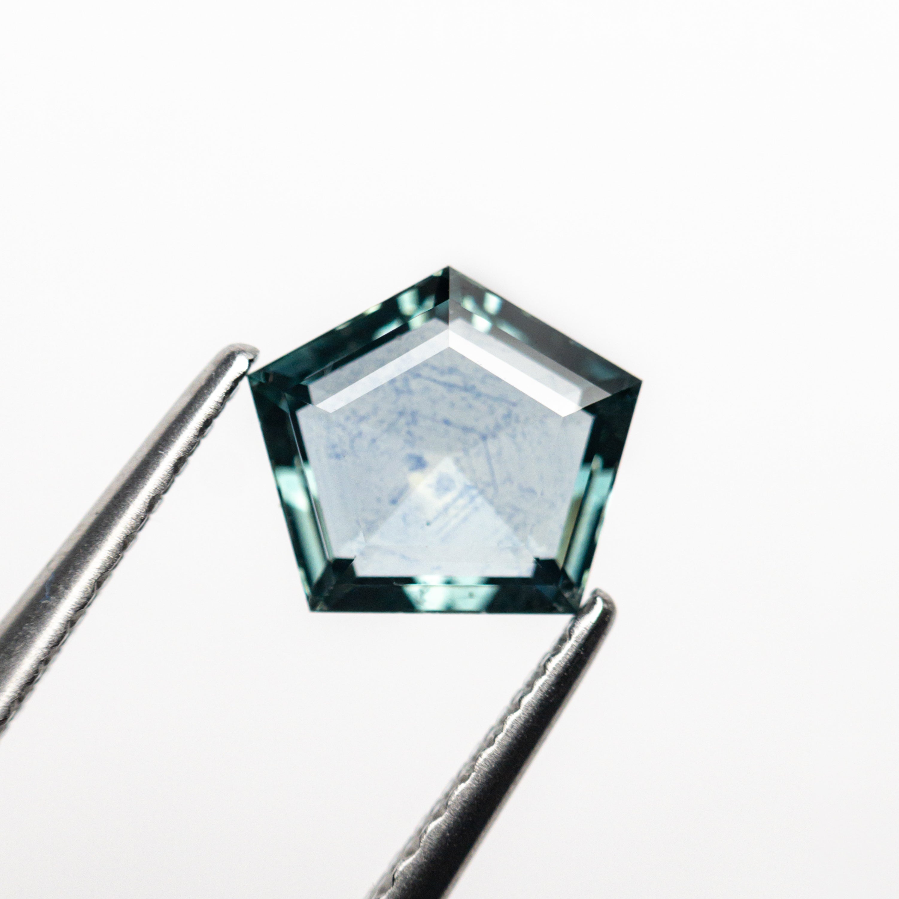 The 1.29ct 7.37x6.51x2.81mm Pentagon Double Cut Sapphire 22434-57 by East London jeweller Rachel Boston | Discover our collections of unique and timeless engagement rings, wedding rings, and modern fine jewellery.