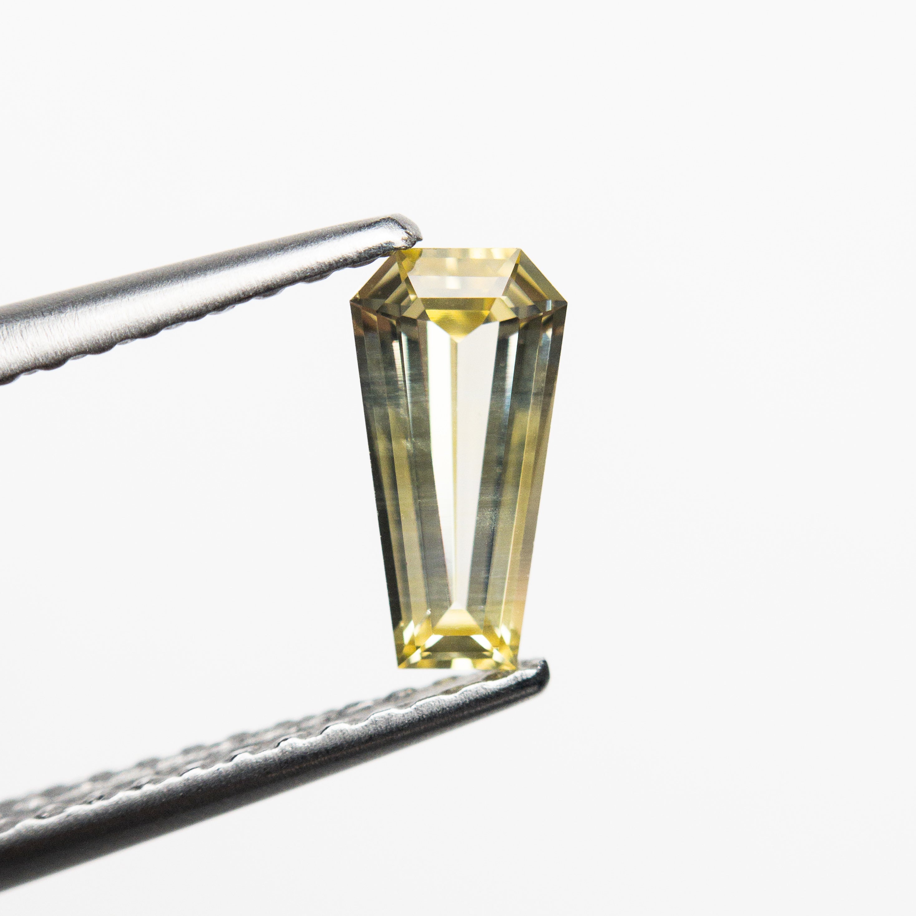 The 0.54ct 7.46x3.81x2.28mm Coffin Step Cut Sapphire 22832-01 by East London jeweller Rachel Boston | Discover our collections of unique and timeless engagement rings, wedding rings, and modern fine jewellery.