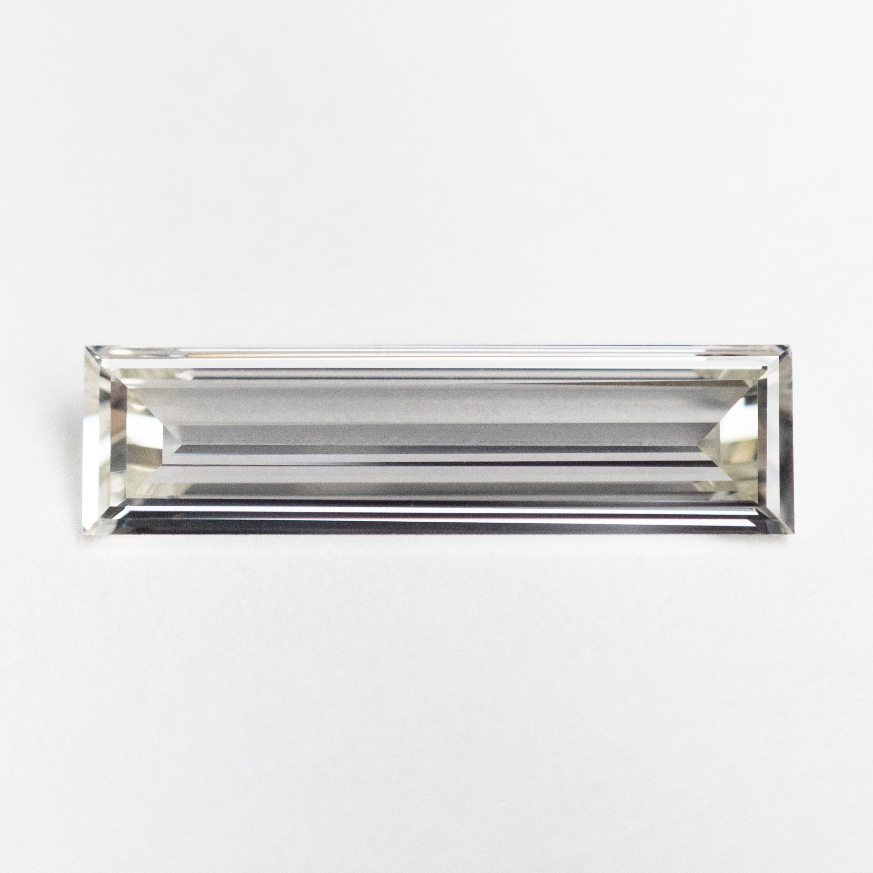 The 1.04ct 15.35x4.17x1.59mm GIA VS2 I Baguette Step Cut 23037-01 by East London jeweller Rachel Boston | Discover our collections of unique and timeless engagement rings, wedding rings, and modern fine jewellery.